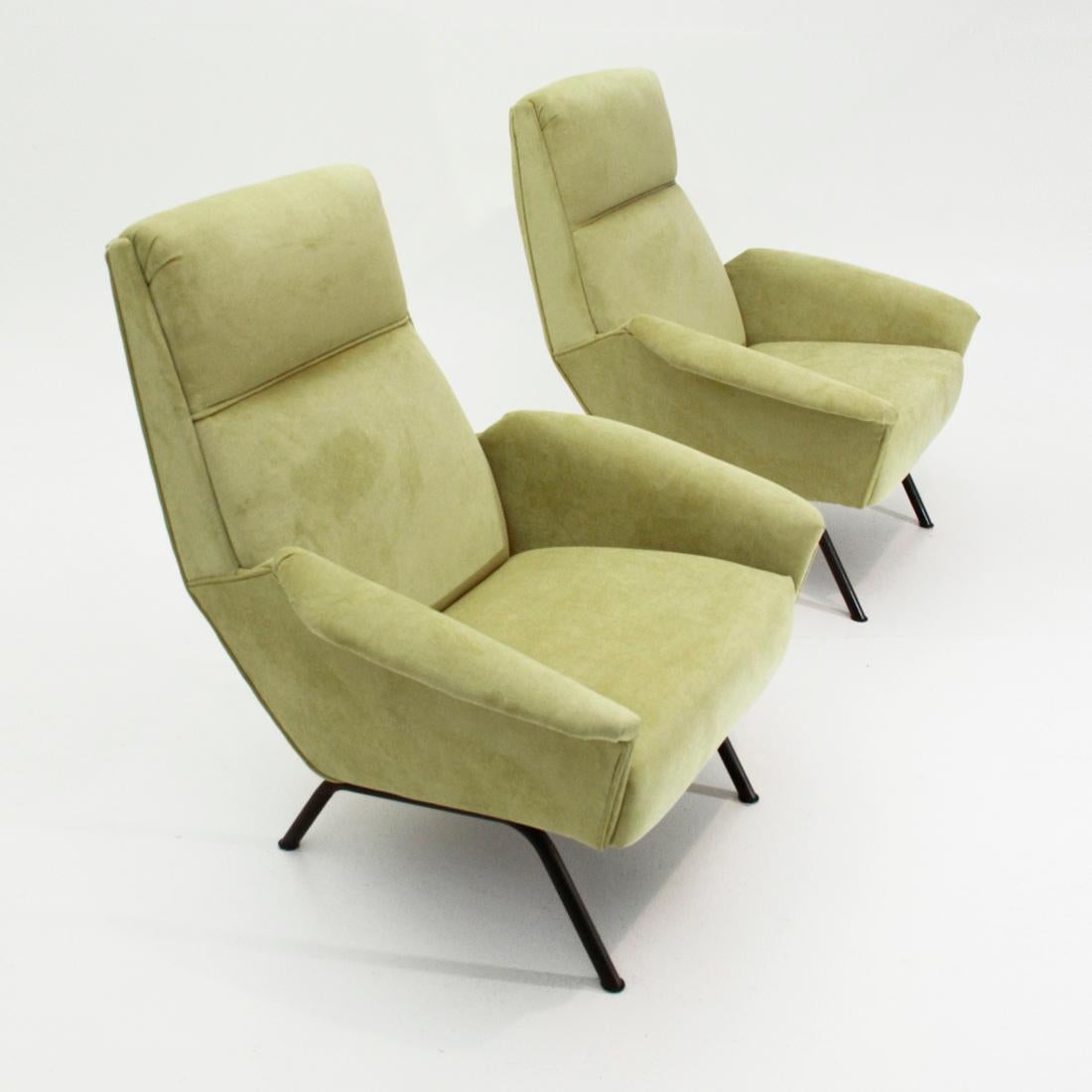 Pair of Italian manufacturing armchairs produced in the 1950s.
Wooden frame padded and lined with new acid green velvet fabric.
Base in black painted metal tubular. 
Good general conditions, some signs due to normal use over time.

Dimensions: