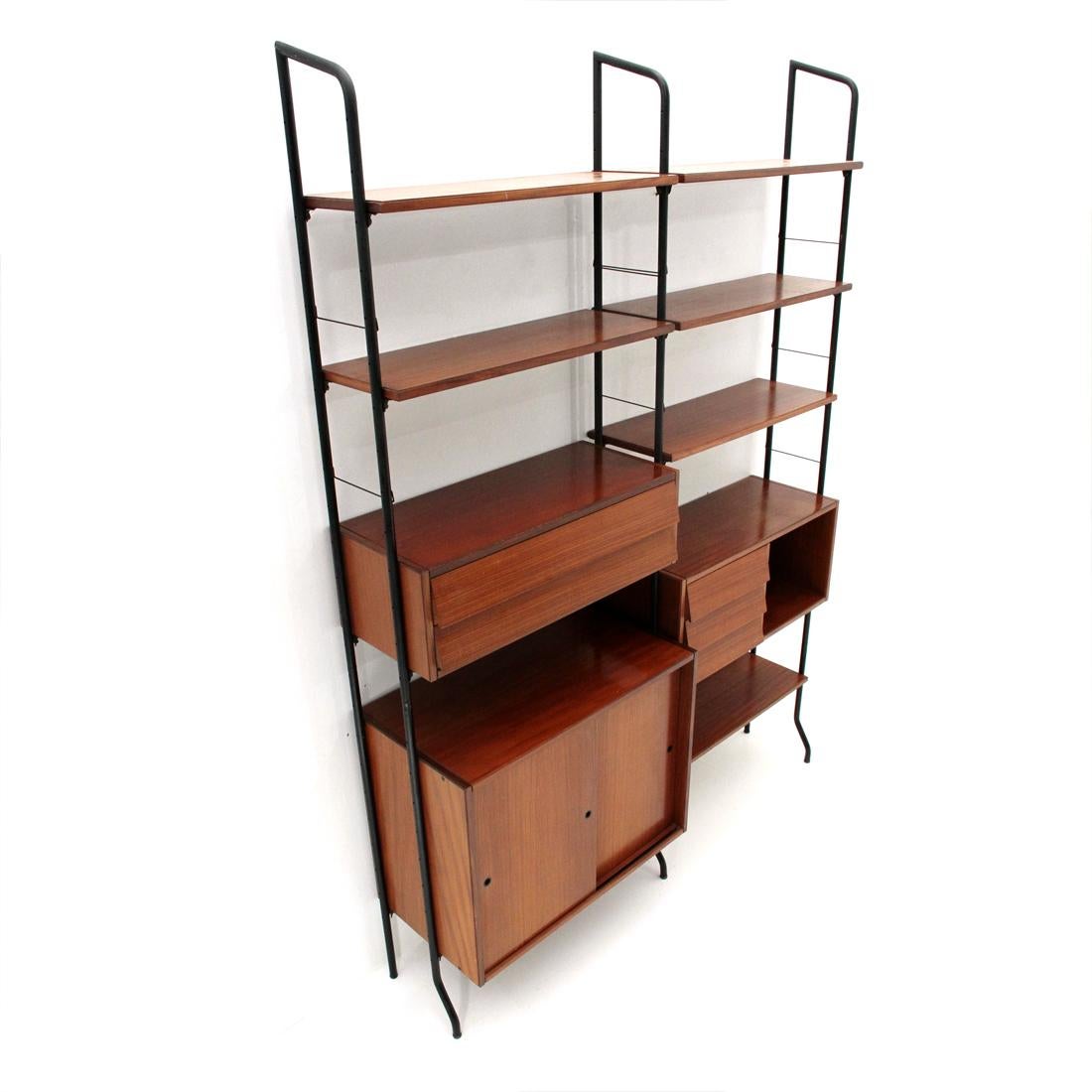 Library produced by Amma di Torino in the 1950s. 
Uprights in black painted folded metal tubing. 
Containers, drawers and shelves in veneered teak wood. 
Brass screws. 
Good general conditions, some signs and haloes due to normal use over