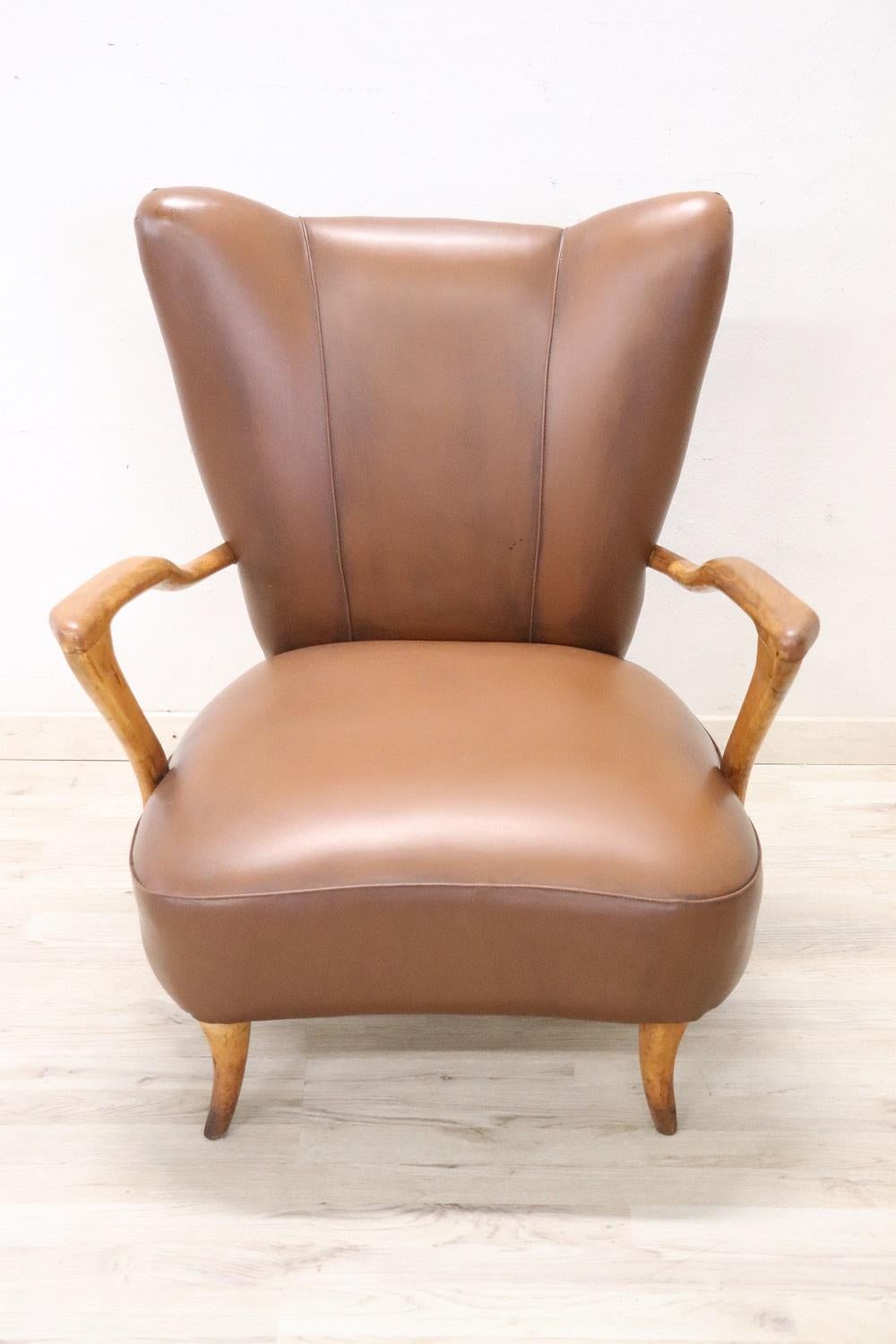 Beautiful italian mid-century armchair with a brown faux leather. These loving armchairs have a comfortable seat. Vintage good conditions. Perfect conditions of padding and faux leather.