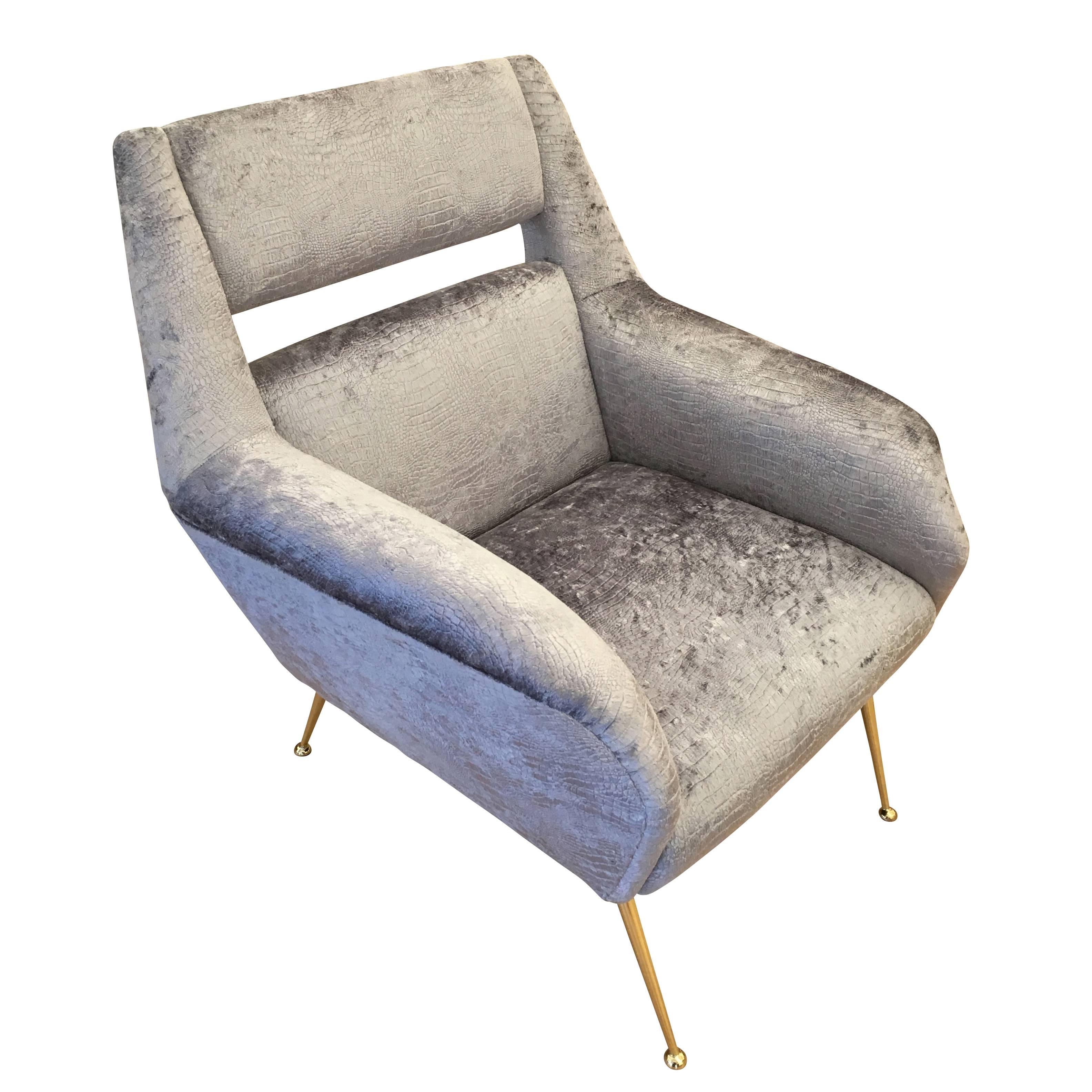 Chic Italian midcentury armchair in the style of Gio Ponti with brass legs and a slit back. Has been re-upholstered in a gray crocodile velvet.

Condition: Newly reupholstered 

Width: 30