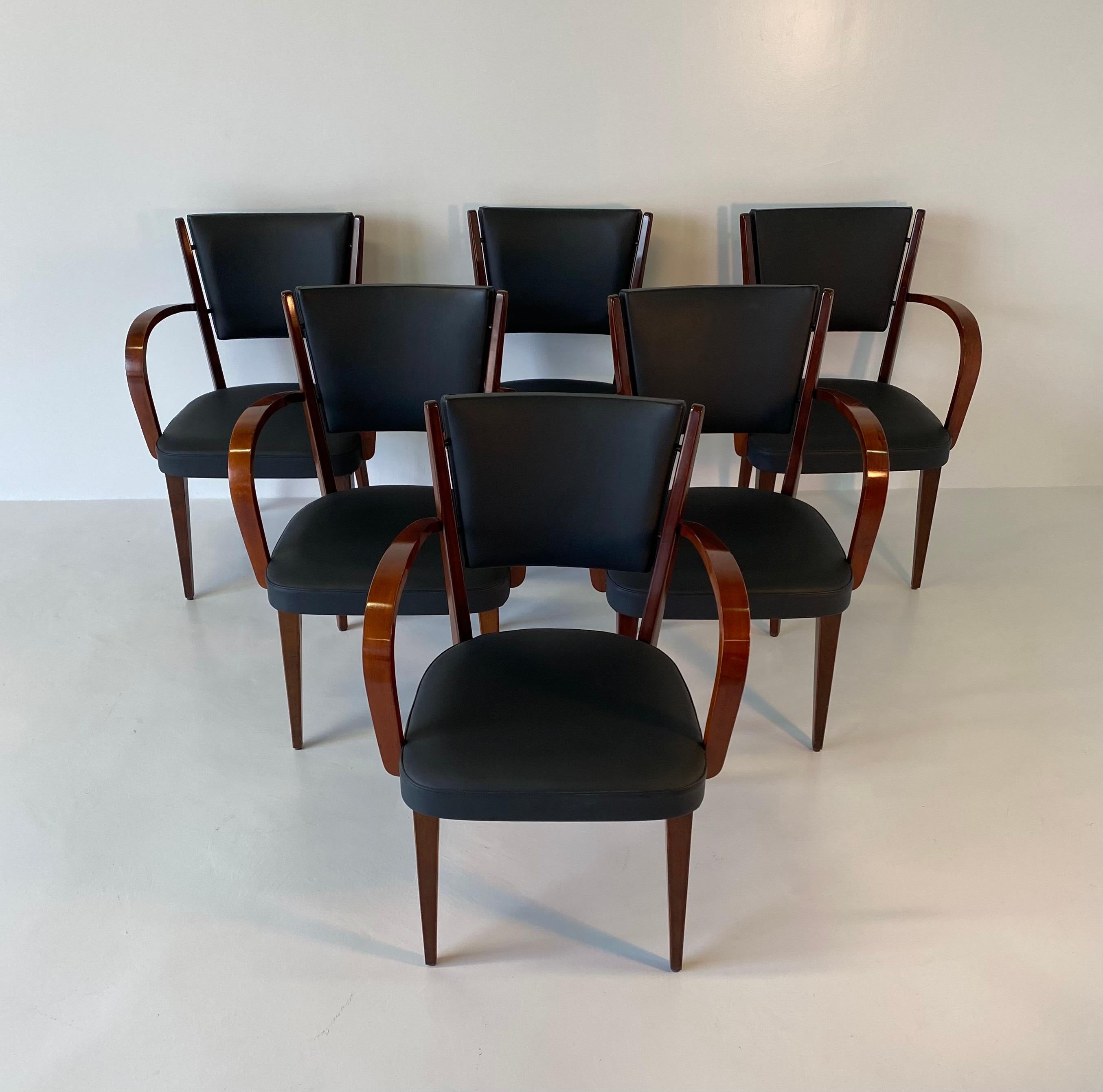 This set of six armchairs was designed and produced in Italy in the 1950s. They are made from walnut with new leather upholstery.