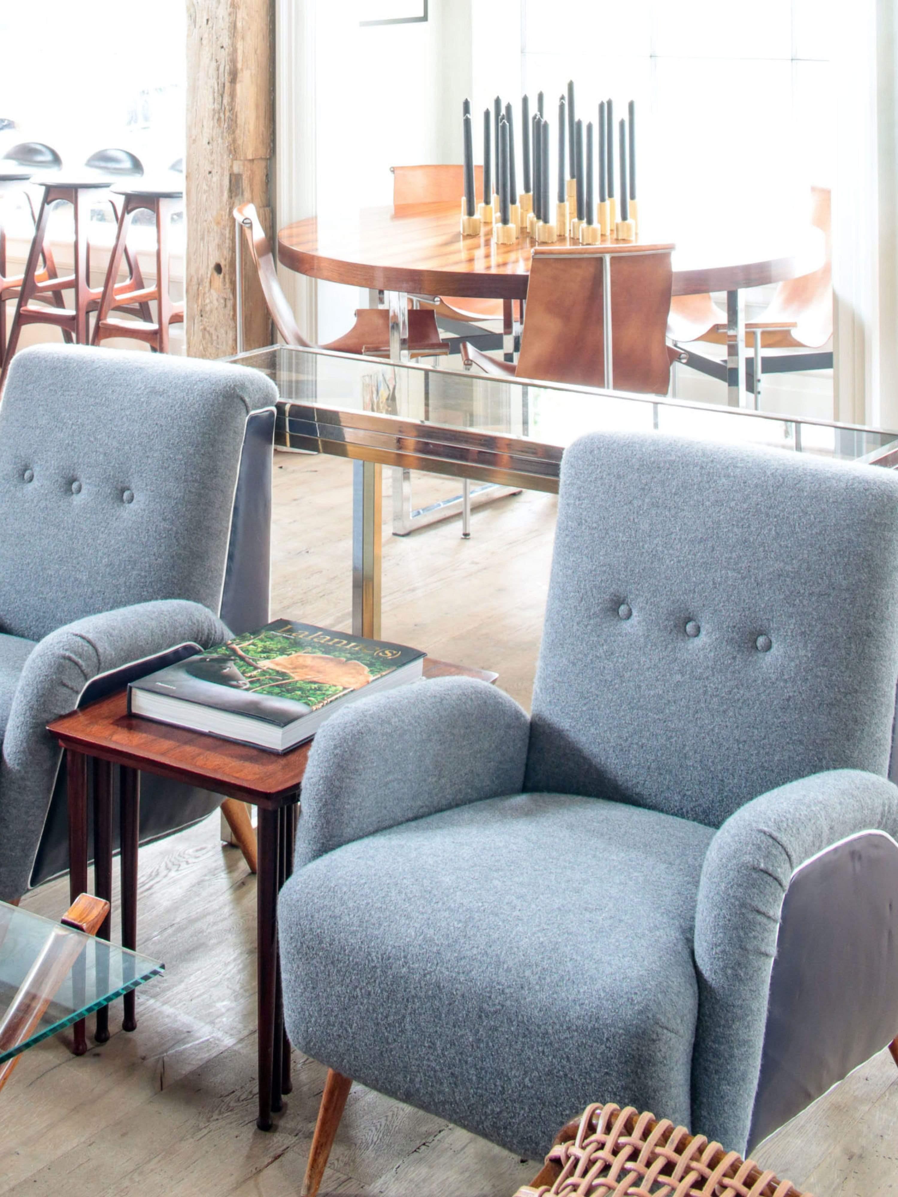These Italian mid-century armchairs feature a timeless design, with boiled wool and leather upholstery for a classic yet durable look. Constructed from strong materials, these armchairs provide sturdy and reliable comfort for long-lasting use.