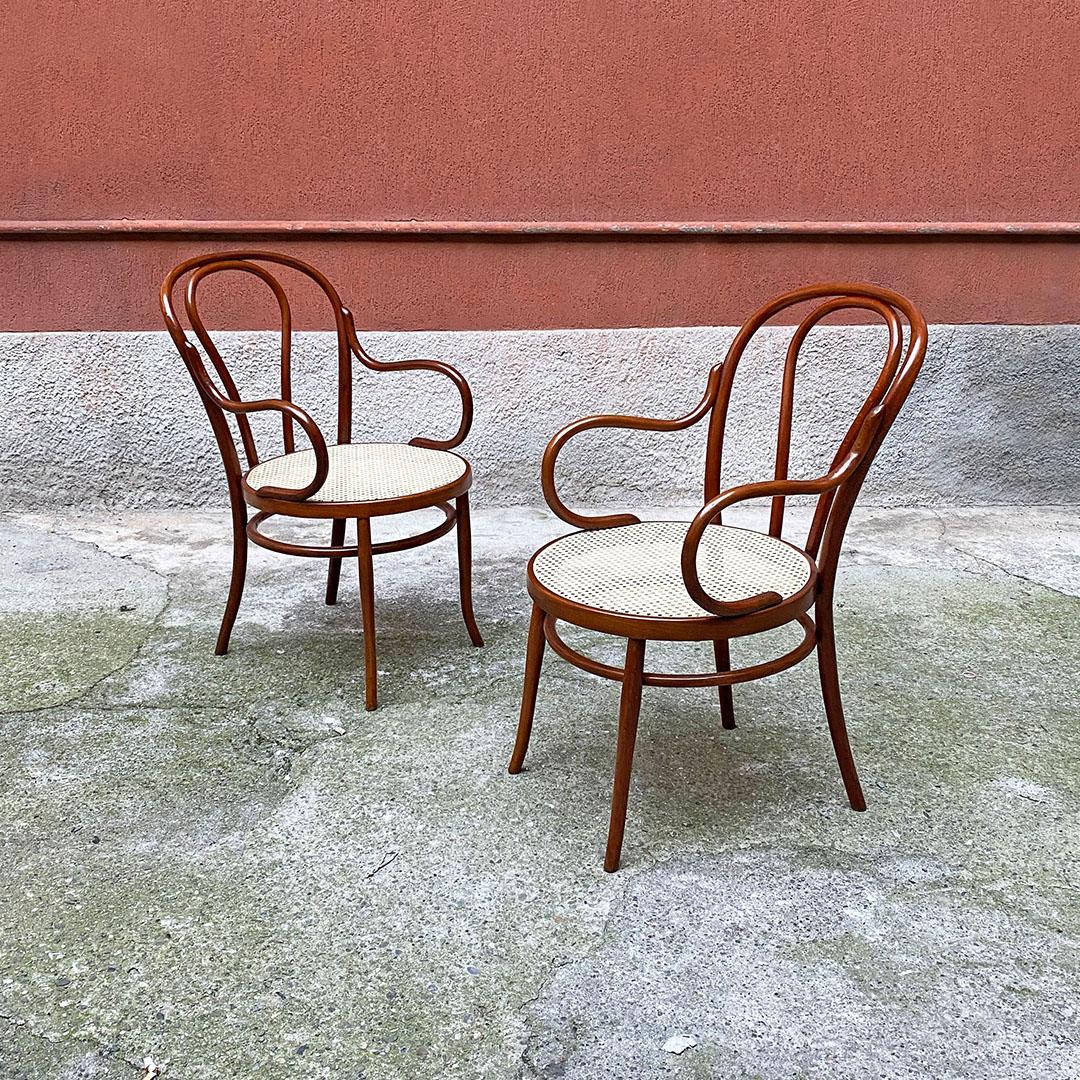 Italian Mid-Century Modern larghe beech and Vienna straw Thonet style chairs with armrests, 1950s
Large chairs or small armchairs with armrests in Thonet style, with Vienna straw seat and curved armrests and with walnut-colored beech