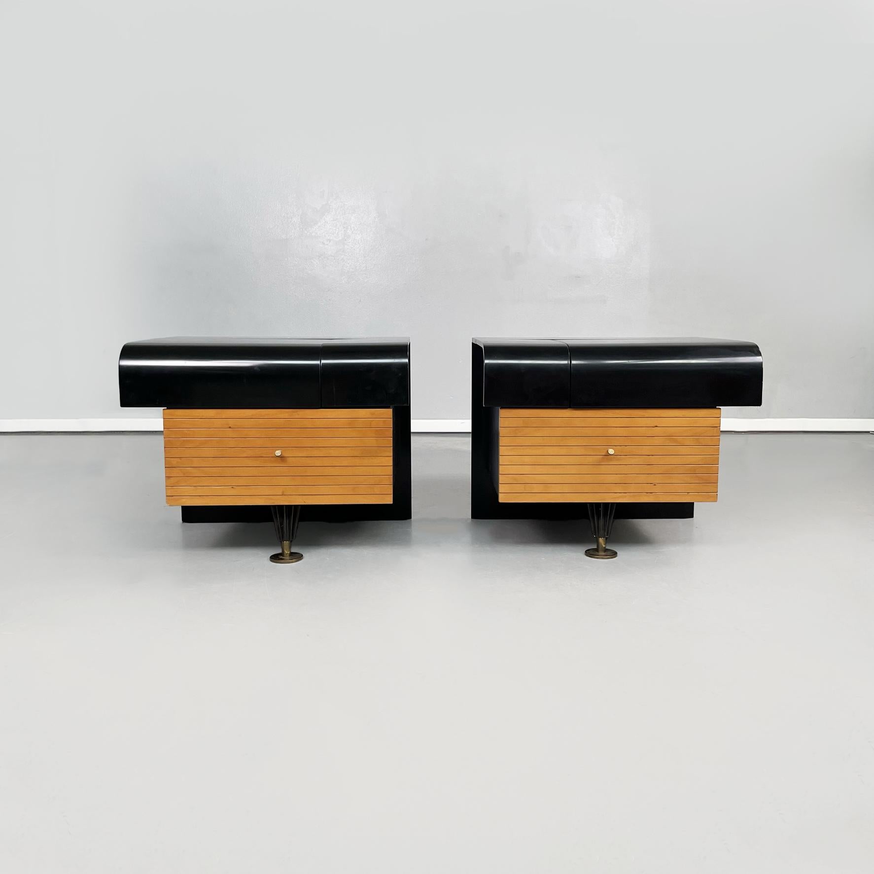Italian mid-century black wooden, brass bedside tables by Pierre Cardin, 1980s
Pair of wooden bedside tables with a rectangular base. The upper top is rectangular with a curved front profile, in black painted wood. There is a compartment with a