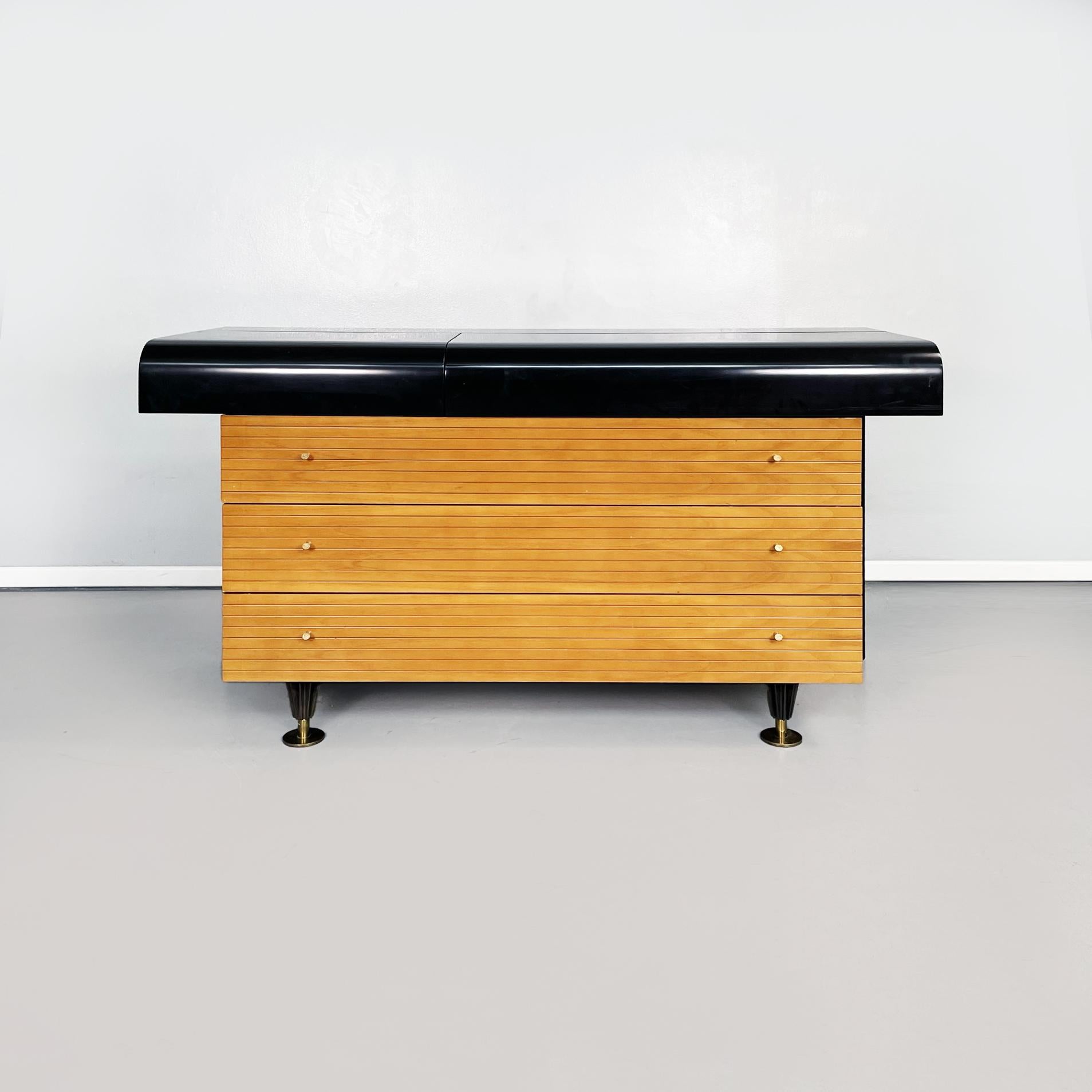 Italian mid-century black wooden, brass console by Pierre Cardin, 1980s
Wooden sideboard with rectangular base. The top of the chest of drawers is rectangular with a curved front profile, in black painted wood. There is a compartment with two
