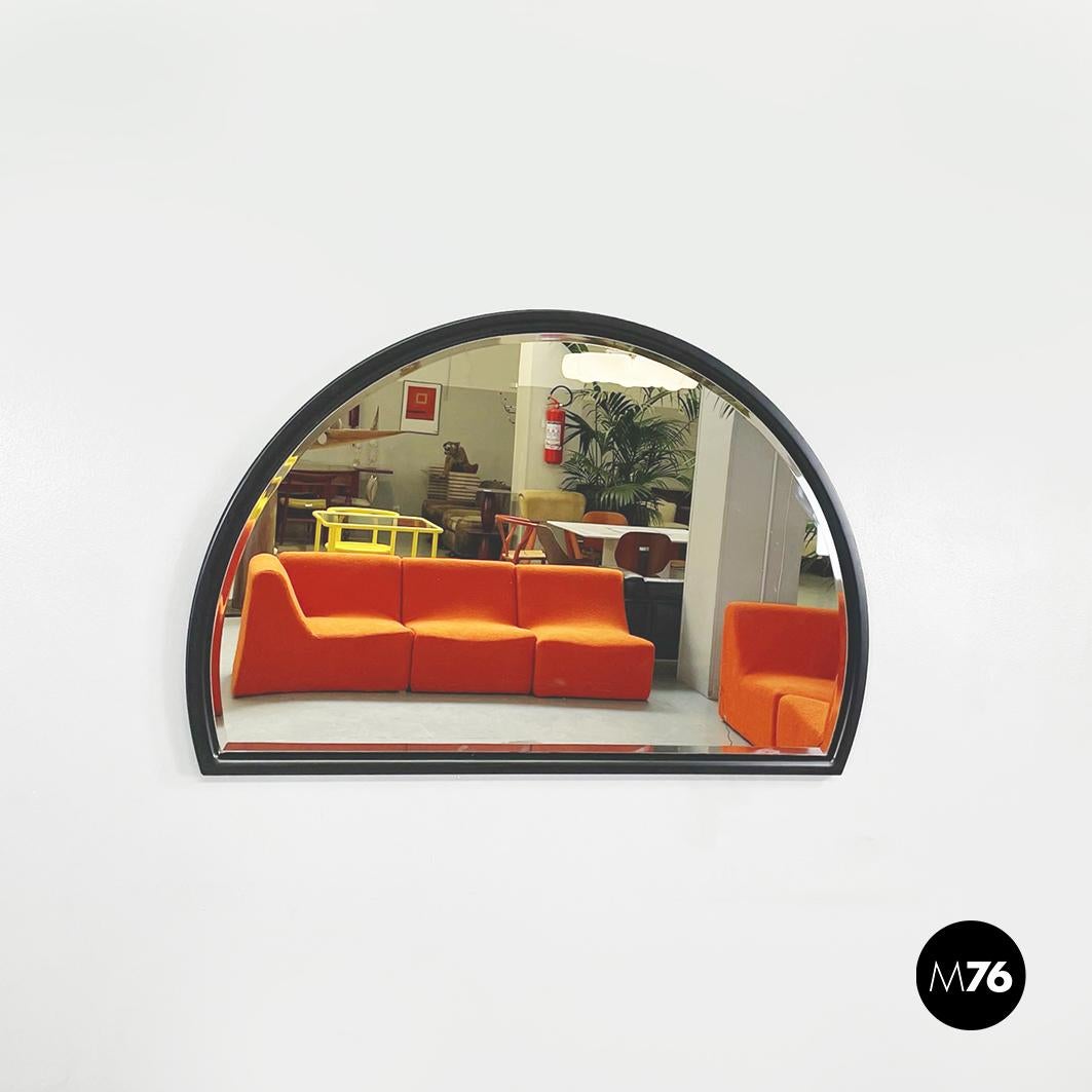 Italian mid-century black wooden semi-oval wall mirror by Pierre Cardin, 1980s
Semi-oval wall mirror with black painted wooden frame.
Produced by Pierre Cardin in 1980s
Very good conditions, with light marks in two places on the frame, that are