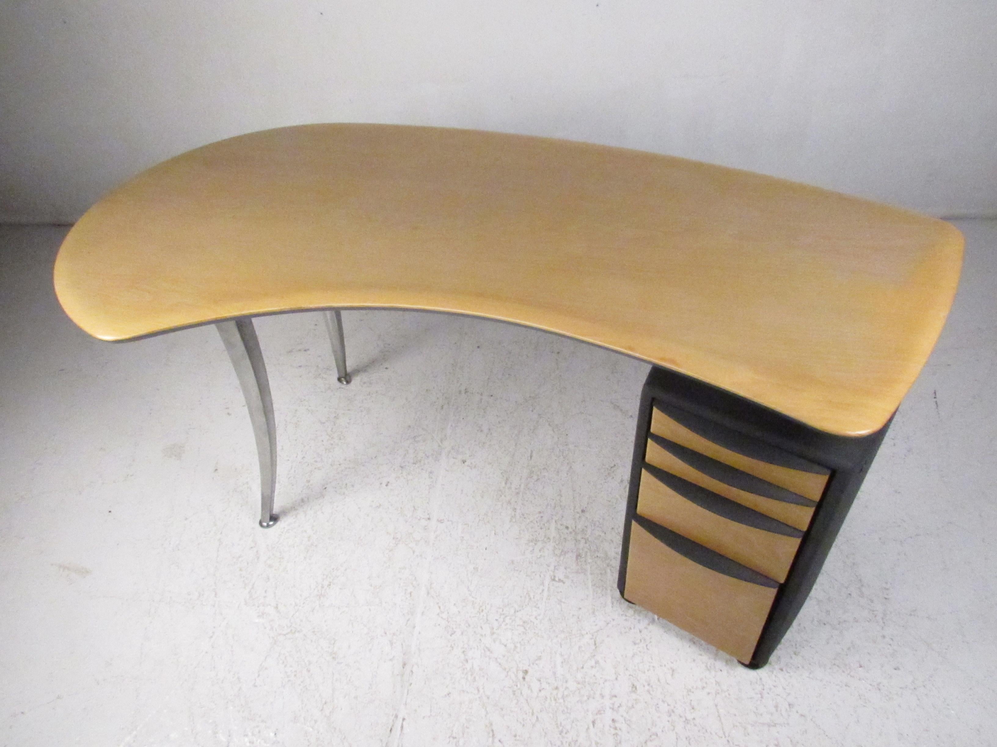 This stunning vintage modern desk boasts curved aluminum legs designed after Luigi Origlia. A lovely two-tone design with a blonde wood top and a thick textured plastic casing. A compact case piece with four hefty drawers that provides ample storage