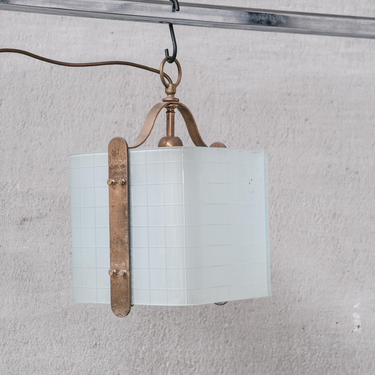 An unusual square glass pendant light, curved sides, with brass construction.

Italy, c1970s.

Opaque glass.

Good vintage condition.

Location: Belgium Gallery.

Dimensions: 25 W x 27 D x 43 Height in cm.

Delivery: POA

We can ship around the