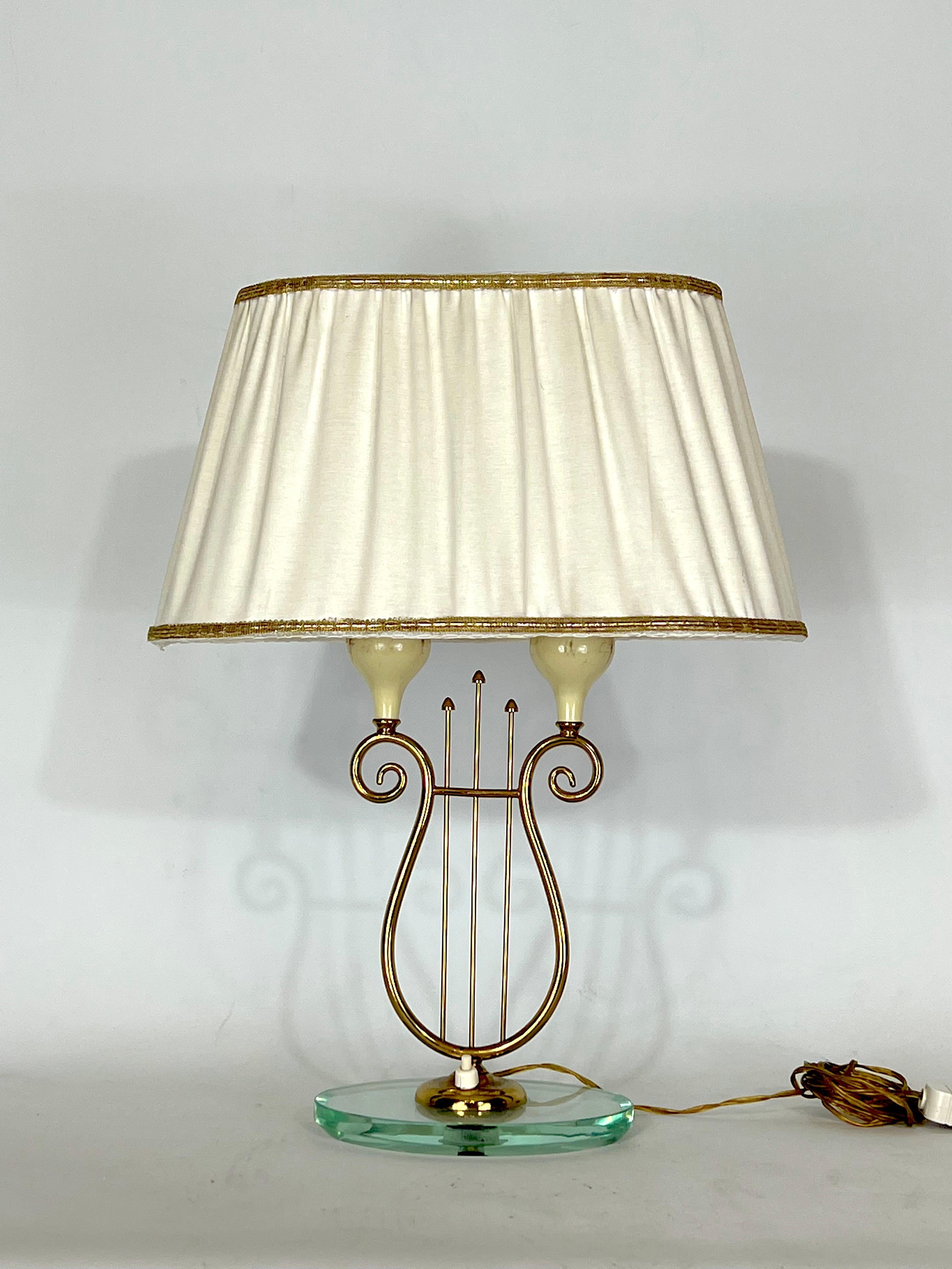 Vintage condition with trace of age and use for this table lamp produced in Italy during the 50s and made from brass and thick glass on the base. Full working with EU standard, adaptable on demand for USA standard.