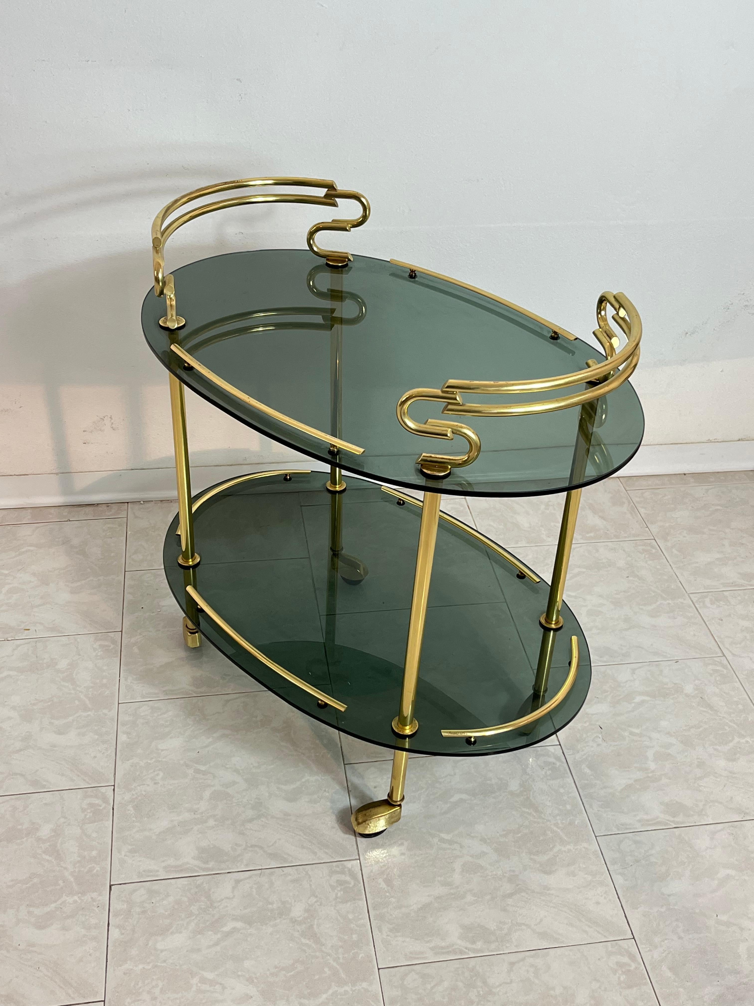 Italian Mid-Century Brass Cart with Caster Wheels, Smoked Glass Tops, 1960s
Very elegant and in good condition, intact glass.