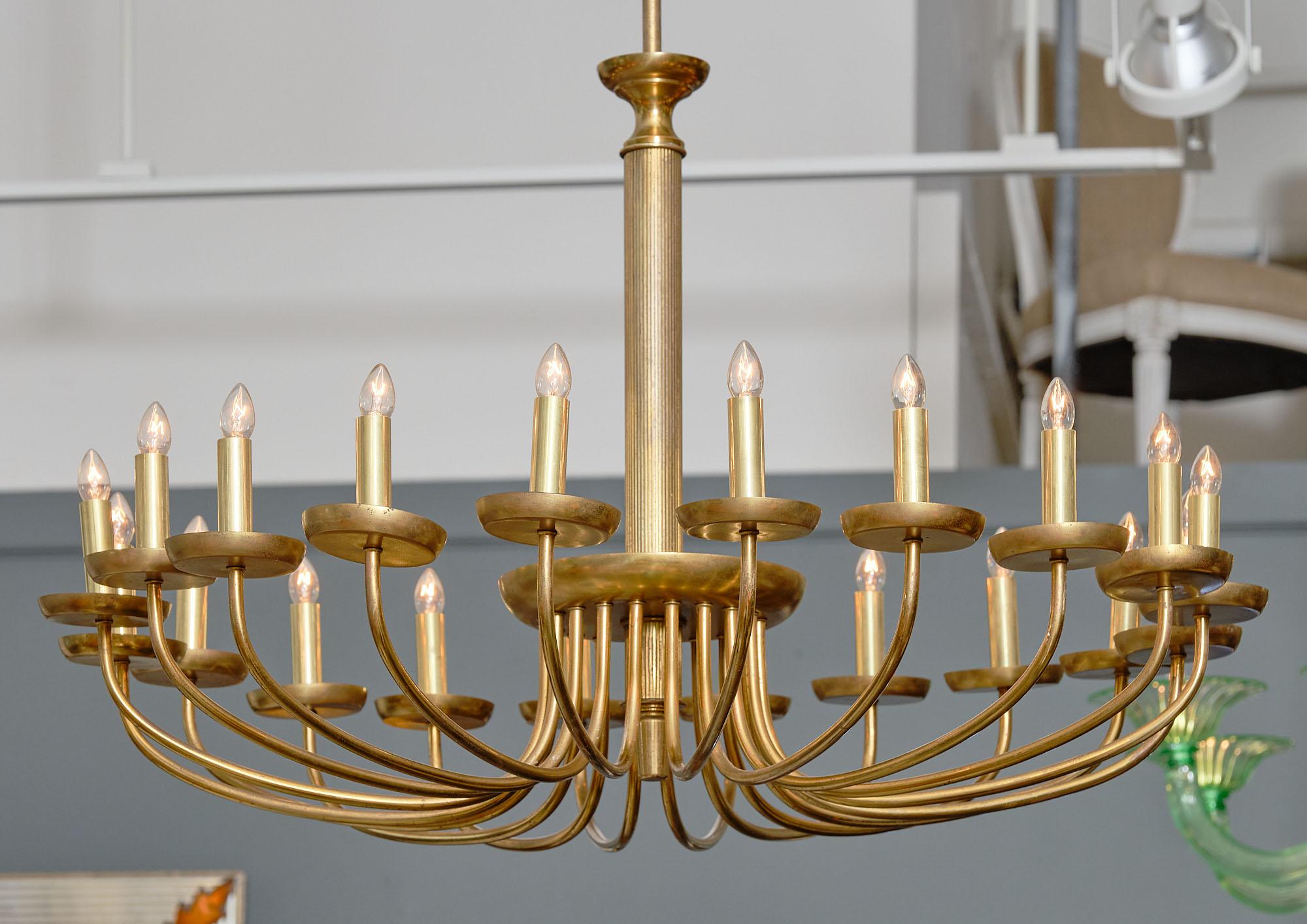 Italian mid-century brass chandelier with 20 branches. This piece is made of solid brass and has been newly wired to US standards.