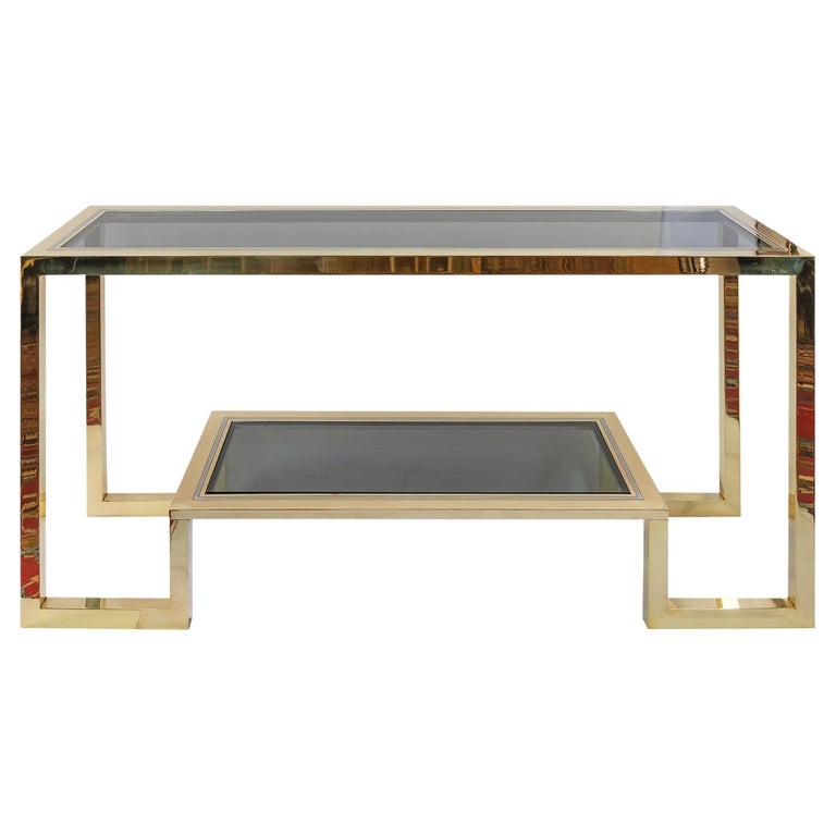 Italian mid-century brass, chrome and glass console table by Romeo Rega from 1970's.
The top and down shelve of this console are with smoked glass.
Overall excellent vintage condition - newly polished.