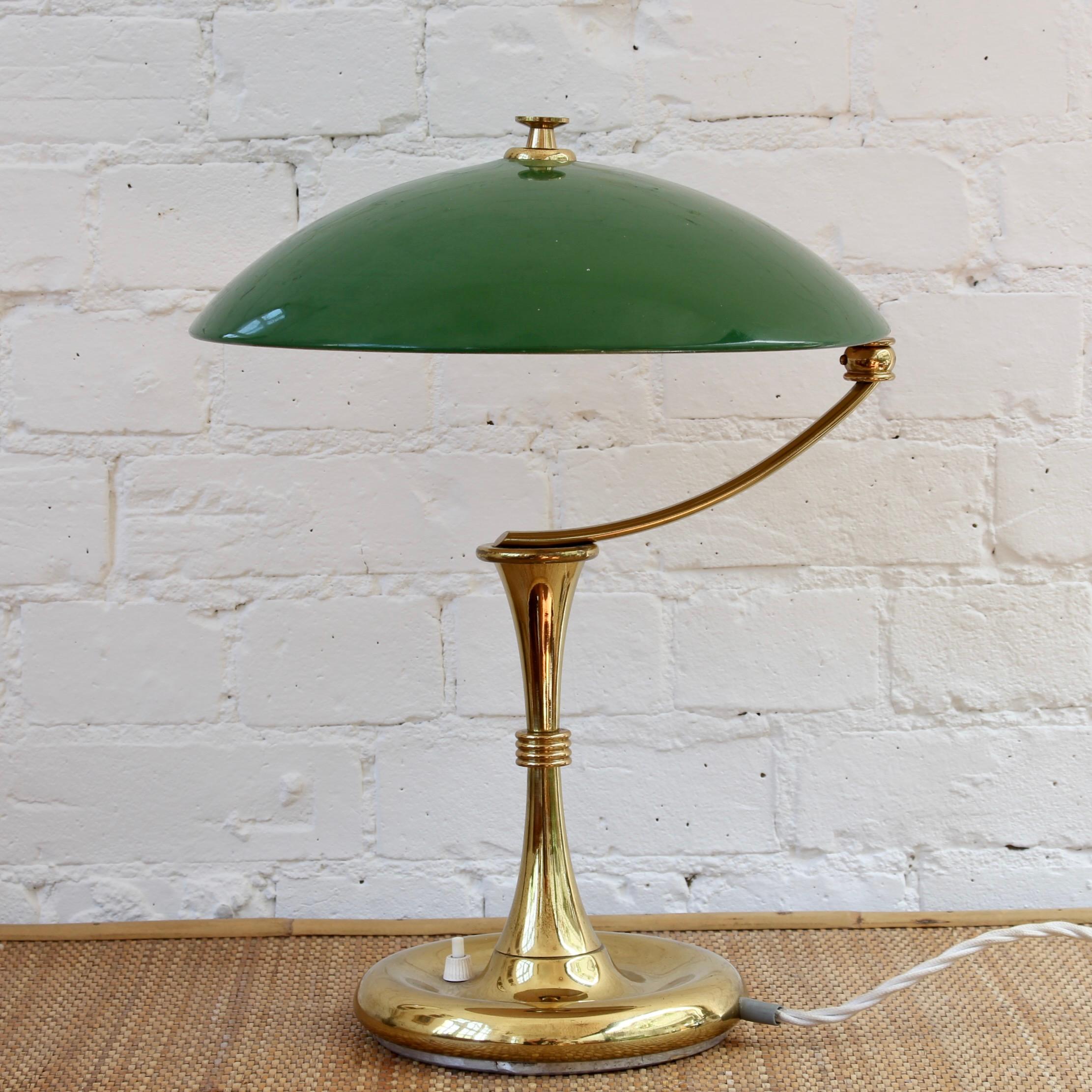 Italian mid-century desk lamp with green shade (circa 1950s). A classic desk lamp with Art Deco detail and rounded green shade which swivels over the weighty base. The lustrous brass overlay features some characterful yet minor blemishing. Currently