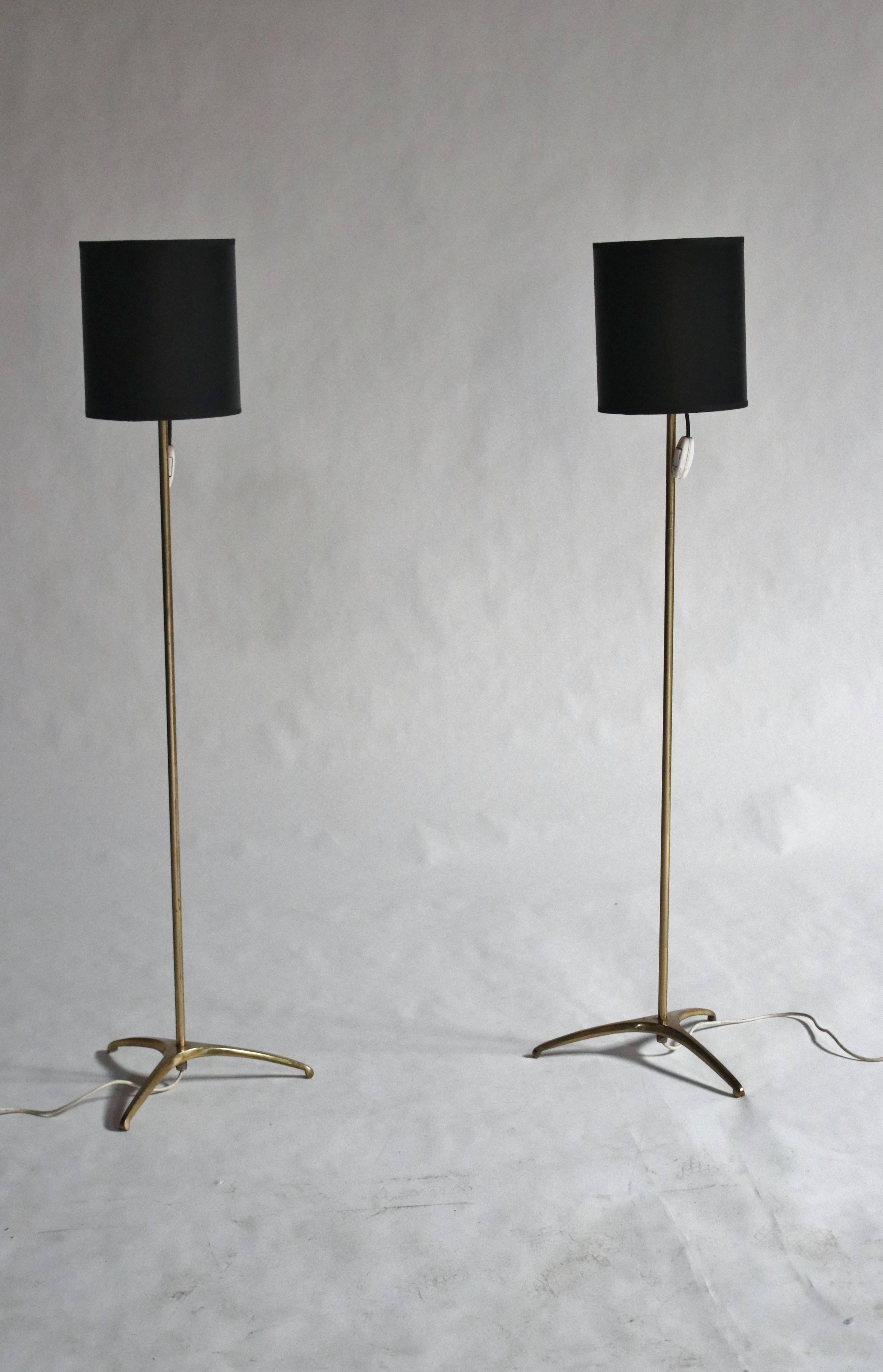 Pair of midcentury minimalist brass floor lamps by Svend Aage Sorenson with new custom black shades.Original European electric plug and equipped with US adapter. In working condition for both Euro and US outlets. Shades measure 8