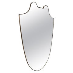Specchio da parete a forma di scudo con cornice d'ottone, anni '50