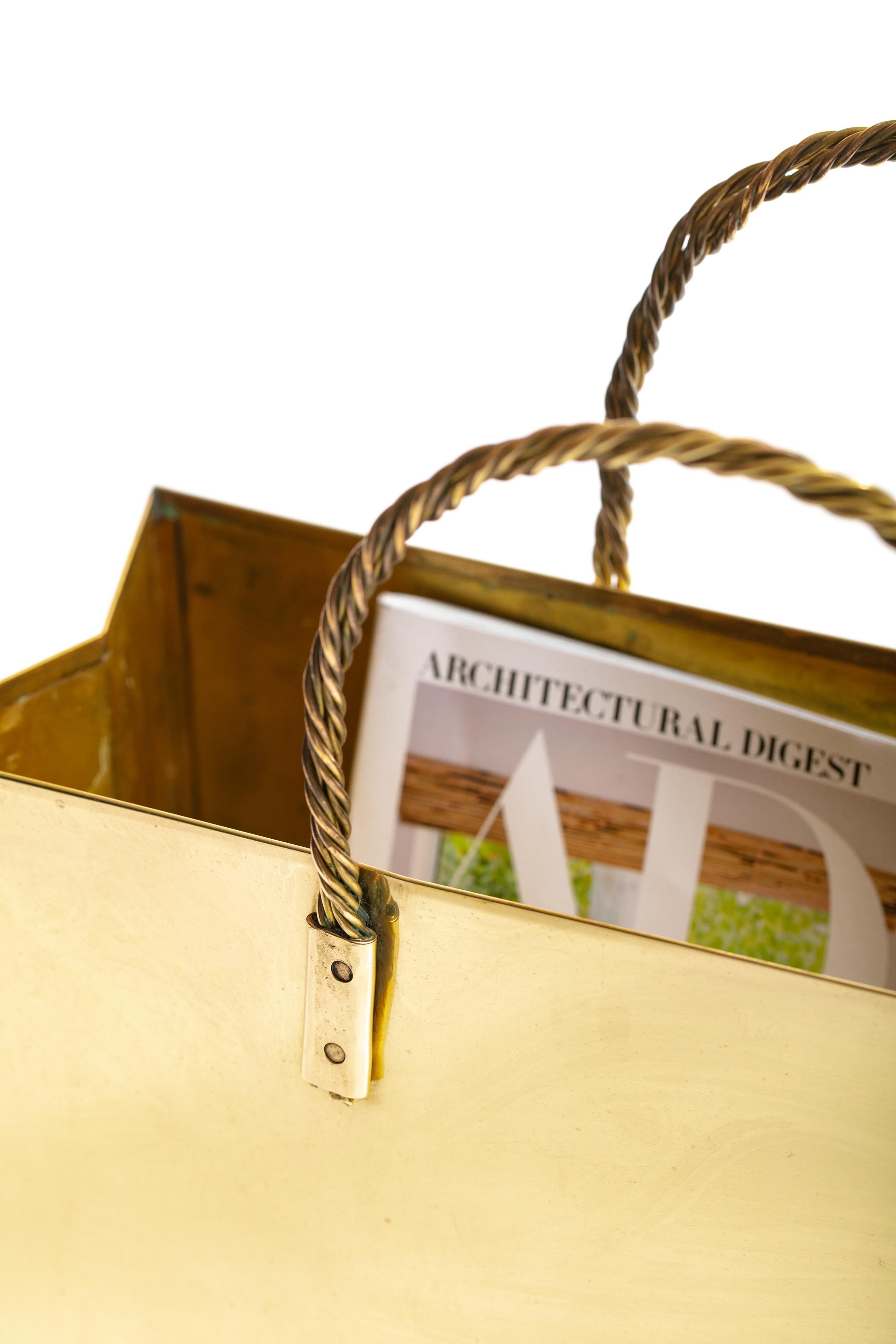 Iconic and oh so chic Italian brass tote bag with brass rope handles and creased sides in the manner of Gio Ponti, circa 1950. Use this glowing brass tote to store your magazines or books chair or bedside, or use as a most luxurious and stylish