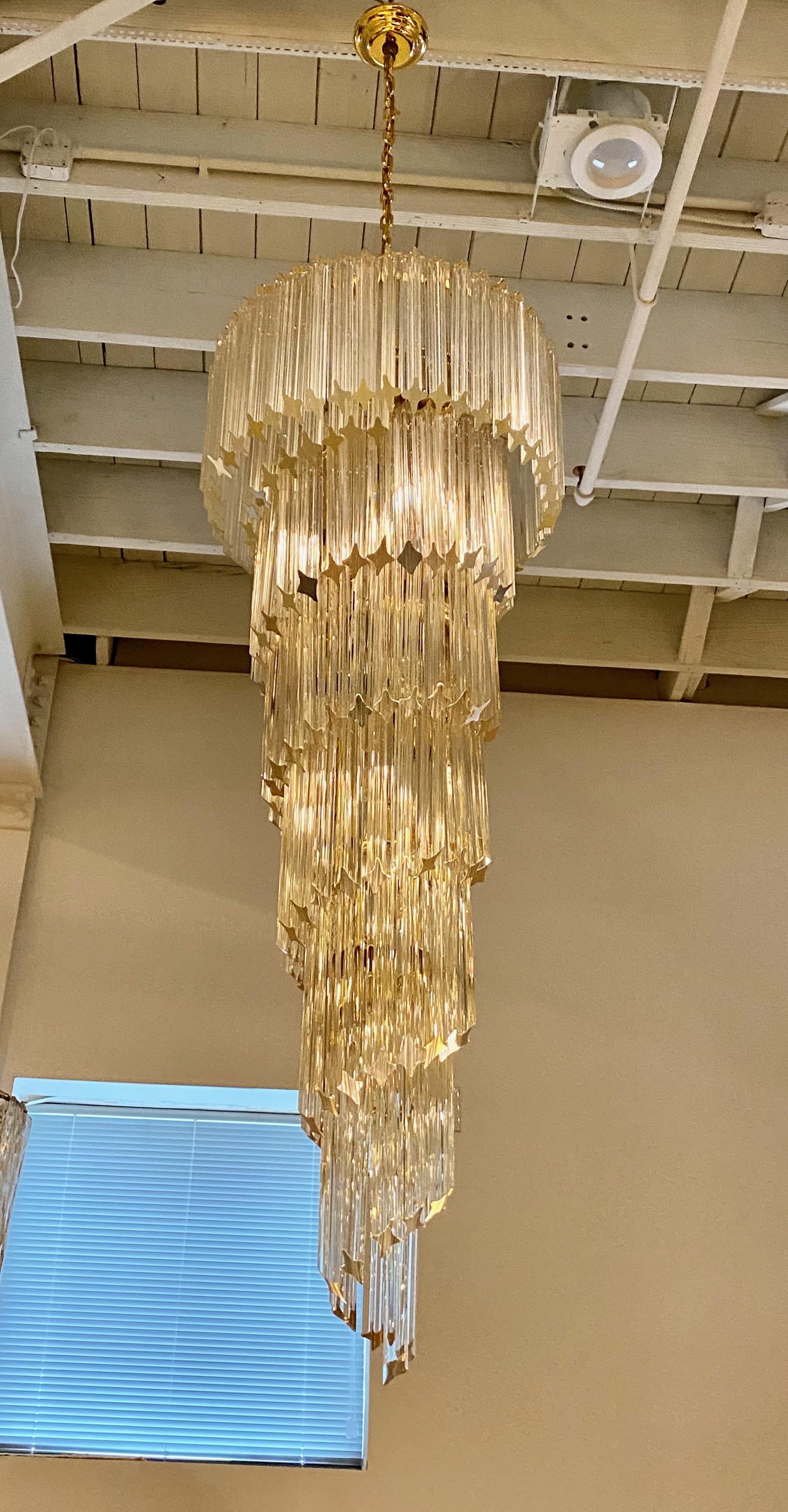 Stunning Mid-Century Modern Italian spiral chandelier. Each of the prisms are solid glass. They hang from hooks onto a spiral brass frame, as pictured. Any amount of chain can be added for custom hanging length of the chandelier. Has been rewired