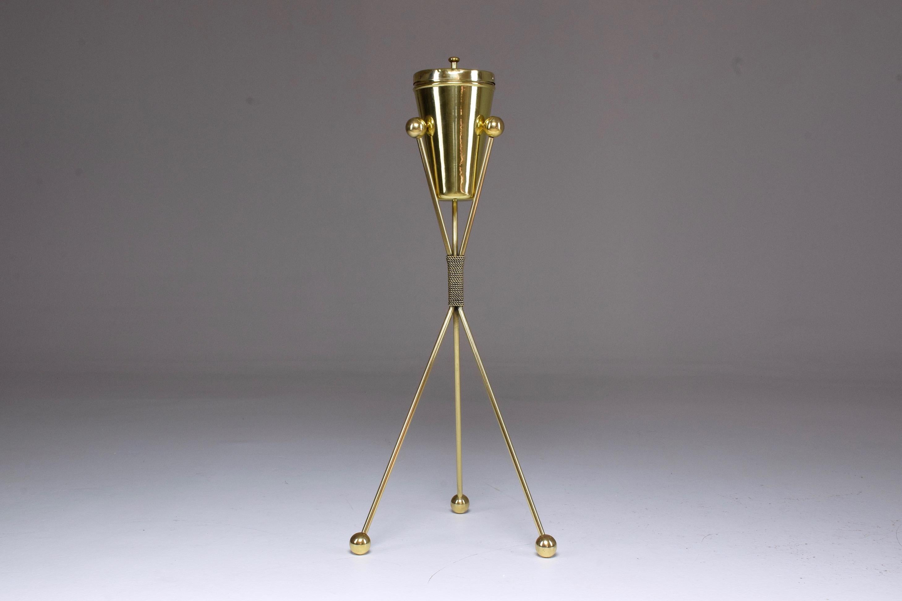 A 20th century vintage standing ashtray in solid gold polished brass with three cigarette holders and a pushdown system sitting on a stylish tripod base with boule shaped endings.
A very cool decorative piece for any living area.
Italy, circa