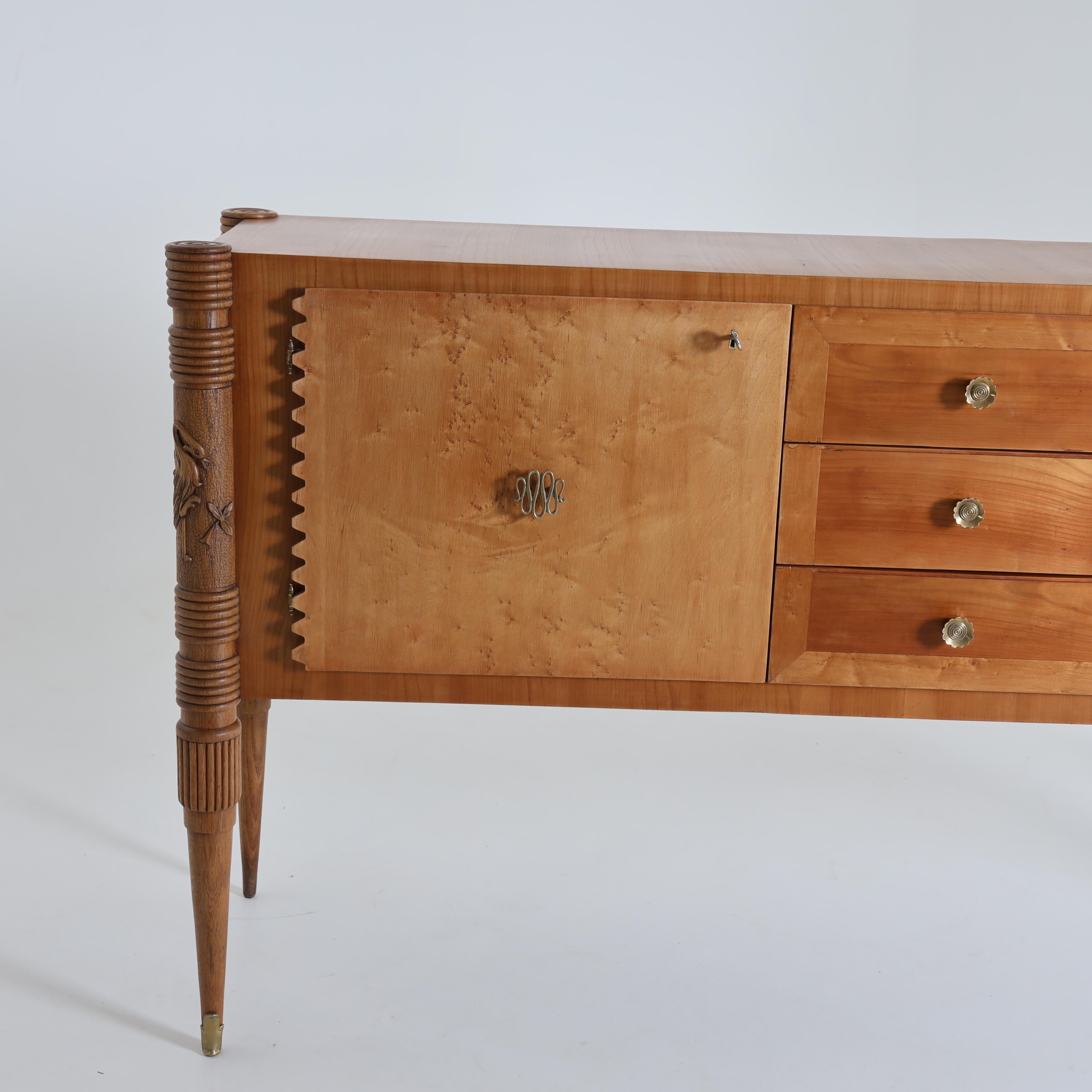 Italian mid century cabinet in the manner of Paolo Buffa. 
Maple, birds eye maple, carved details, patinated brass details.