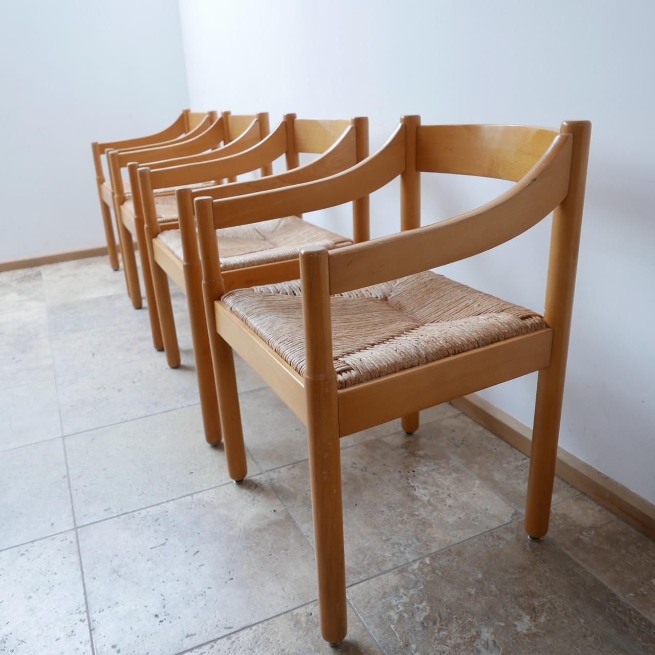 A set of Italian armchairs in the manner of Vico Magistretti, 'Carimate' model.

Italy, circa 1960s but probably retailed in HEALS London along the same period.

Stained wood with upholstered seats,the rush is generally in good condition, the