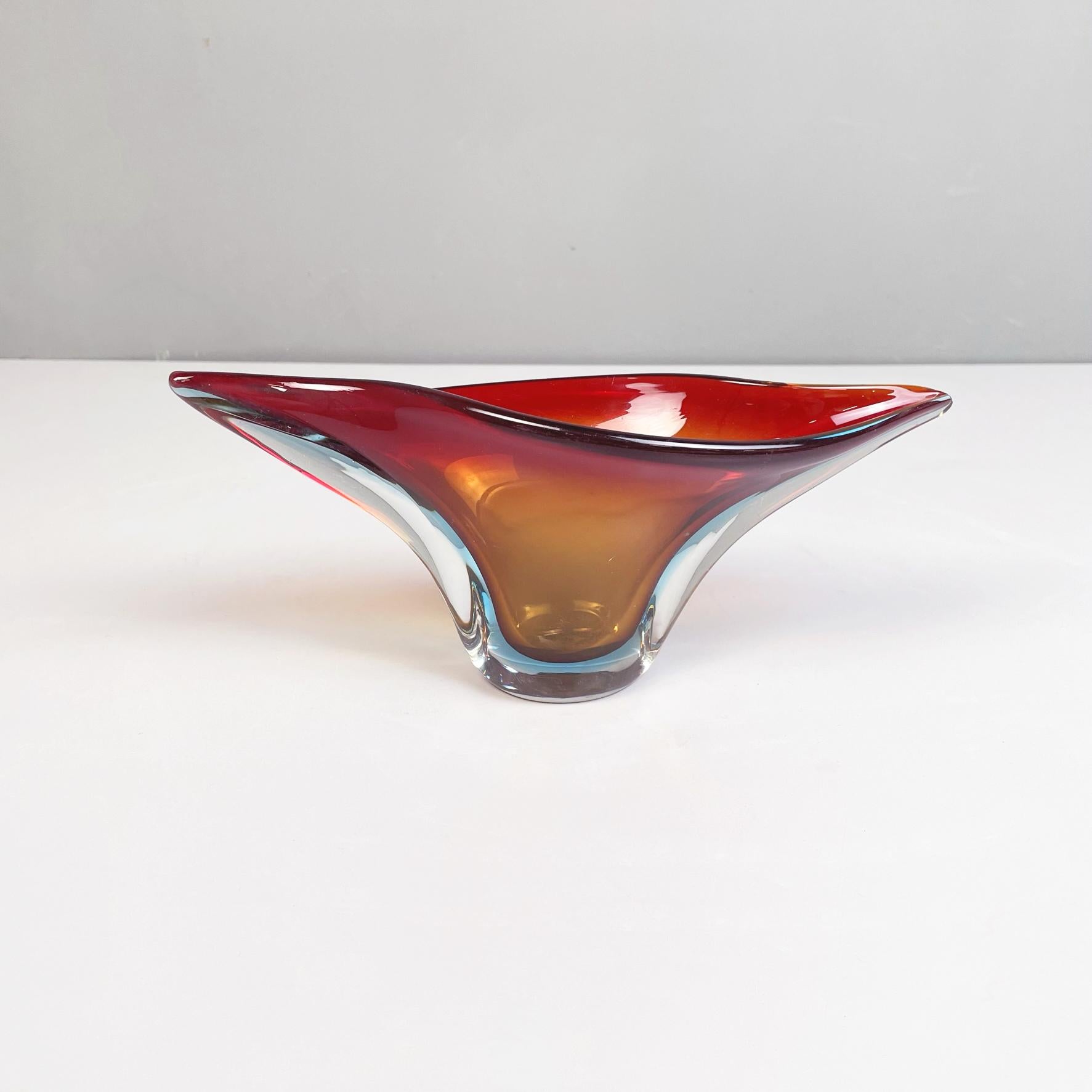 Italian midcentury Centerpiece in yellow, red and blue Murano glass, 1960s
Irregular shaped centerpiece in Murano glass. The main colors are yellow and red with light blue undertones. It can also be used as a pocket emptier.
1960s. Belonging to