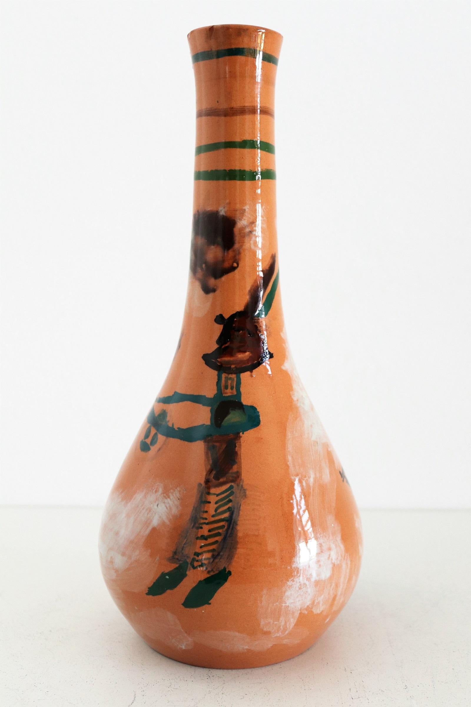 Gorgeous and rare, unique ceramic vase hand painted and signed with G.R. by artist from Italian ceramic studio Orobico Arte Artigianato (ART RUMI) in the 1950s.
The vase is made of ceramic like red clay and hand painted with several naive