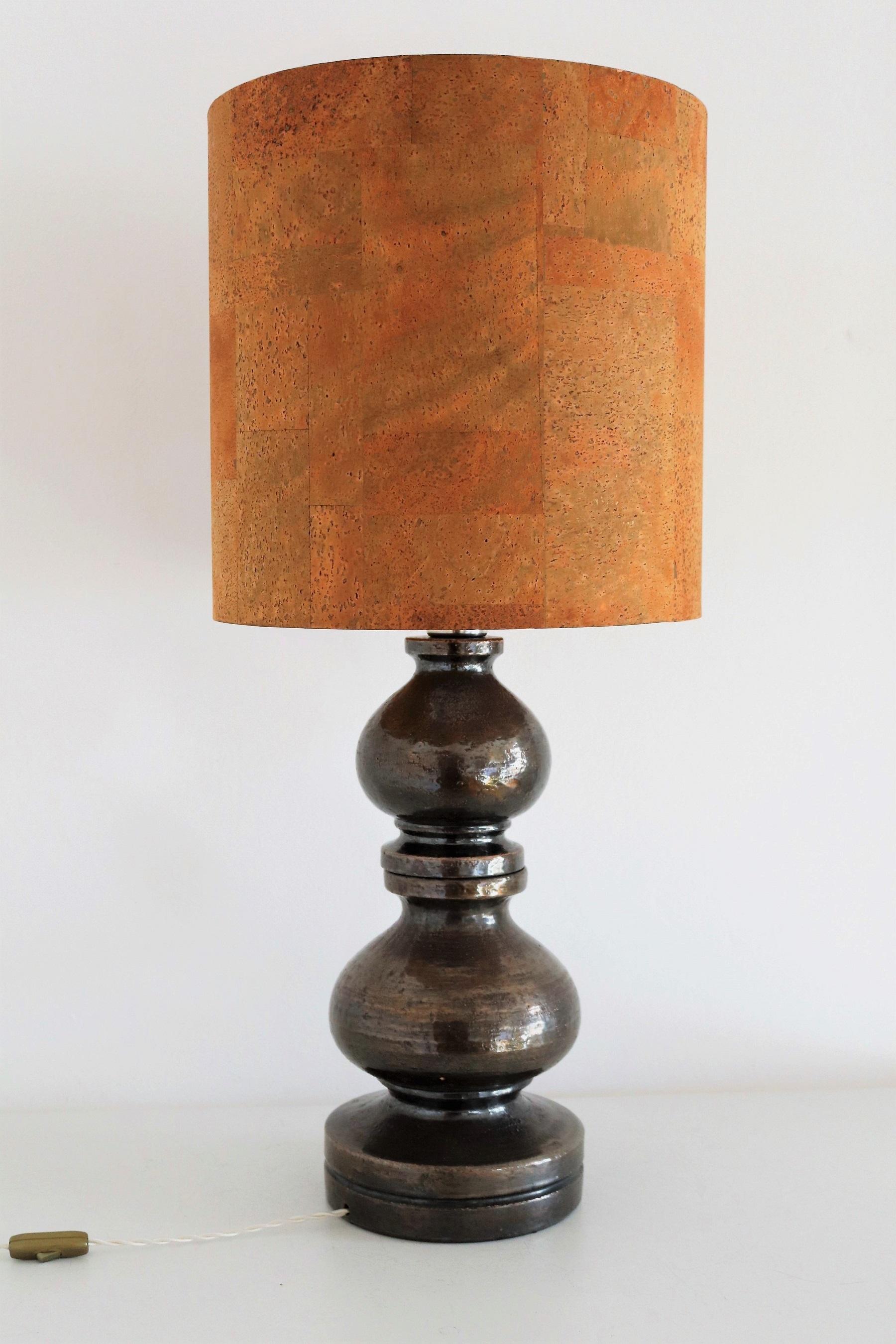 Gorgeous tall table lamp handmade of big and heavy ceramic base in dark anthracite - brown color.
Designed by Aldo Londi and produced by Bitossi of Montelupo Fiorentino, Italy, in the 1960s.
The lampshade is still the original in cork material, of