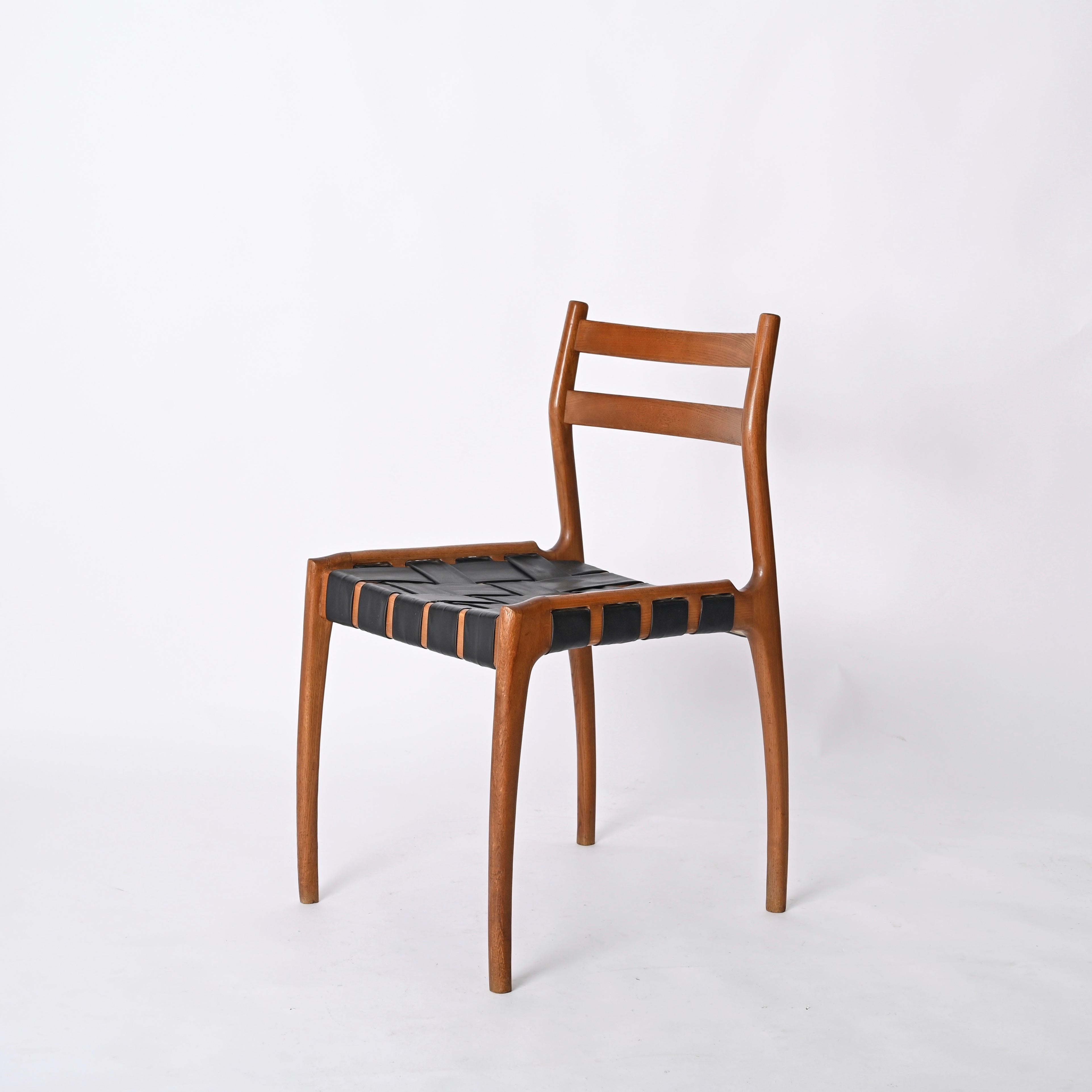 Gorgeous mid-century chair in oak wood with black leather seat. This charming and unique chair was designed by Piero Palange and Werther Toffoloni for Montina in Italy during the 1960s.  

This rare chair is extremely light and has a charming design