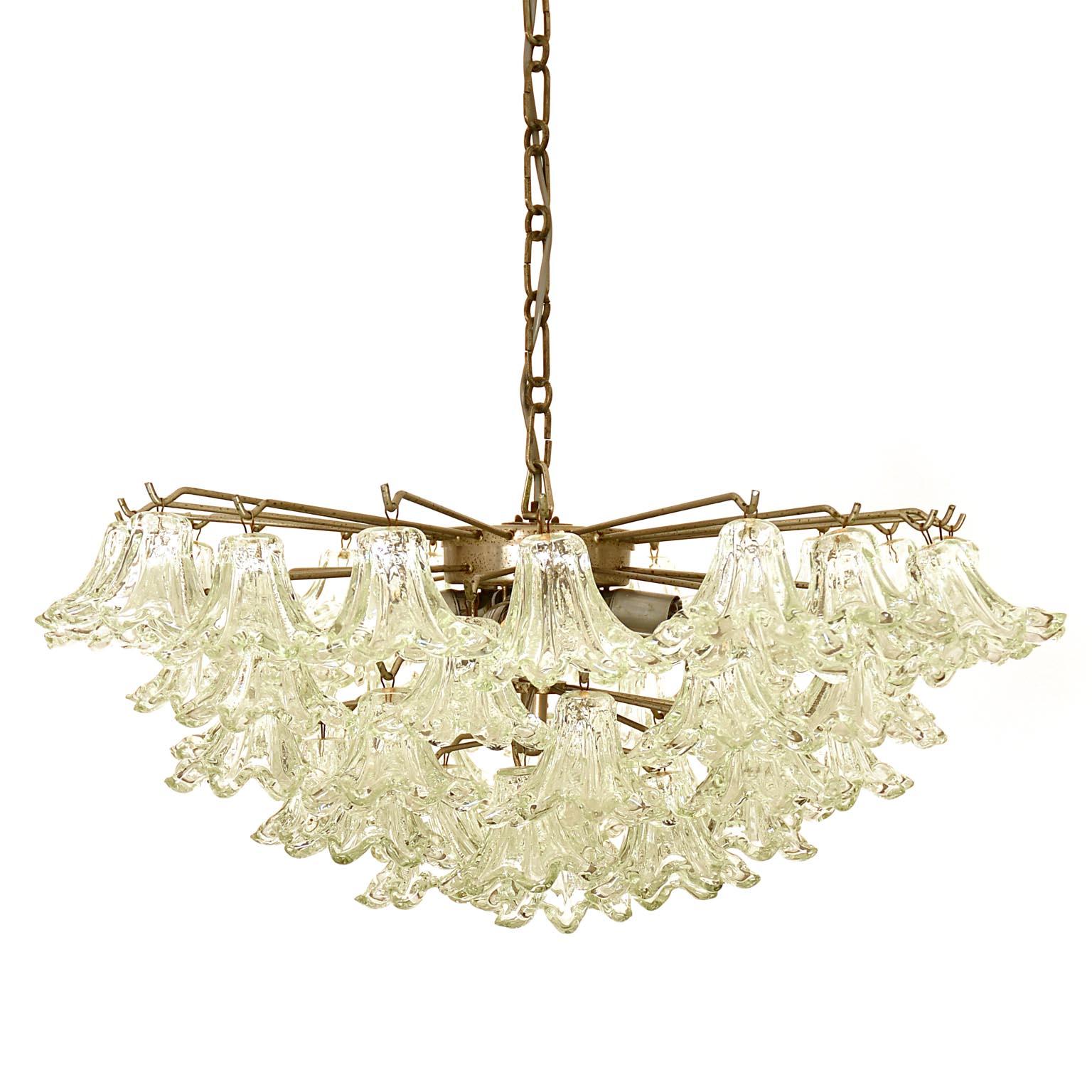 Mid-century glass chandelier from Italy. Nickel plated base with glass blossoms. Each blossom is fixed with a tiny metal ring.
The height of the chandelier without the chain is 24 cm / 9.45 in. We found this piece in a house near Venice and