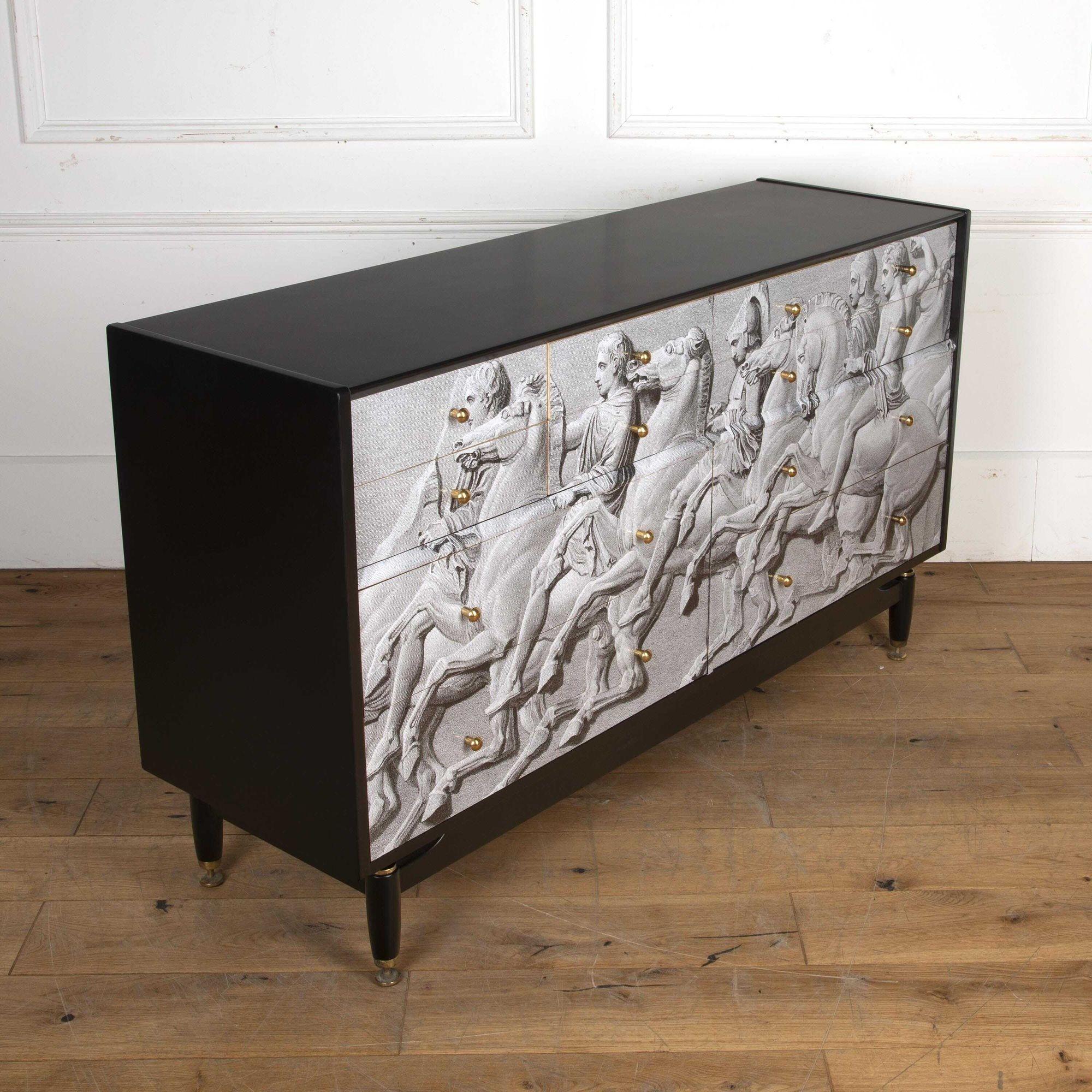 Fabulous Fornasetti style Italian Mid-Century chest of drawers.
Dating to the 1970s this chest has been recently recovered with a Fornasetti pattern.
Featuring four larger drawers at the bottom and eight smaller drawers at the top this is a