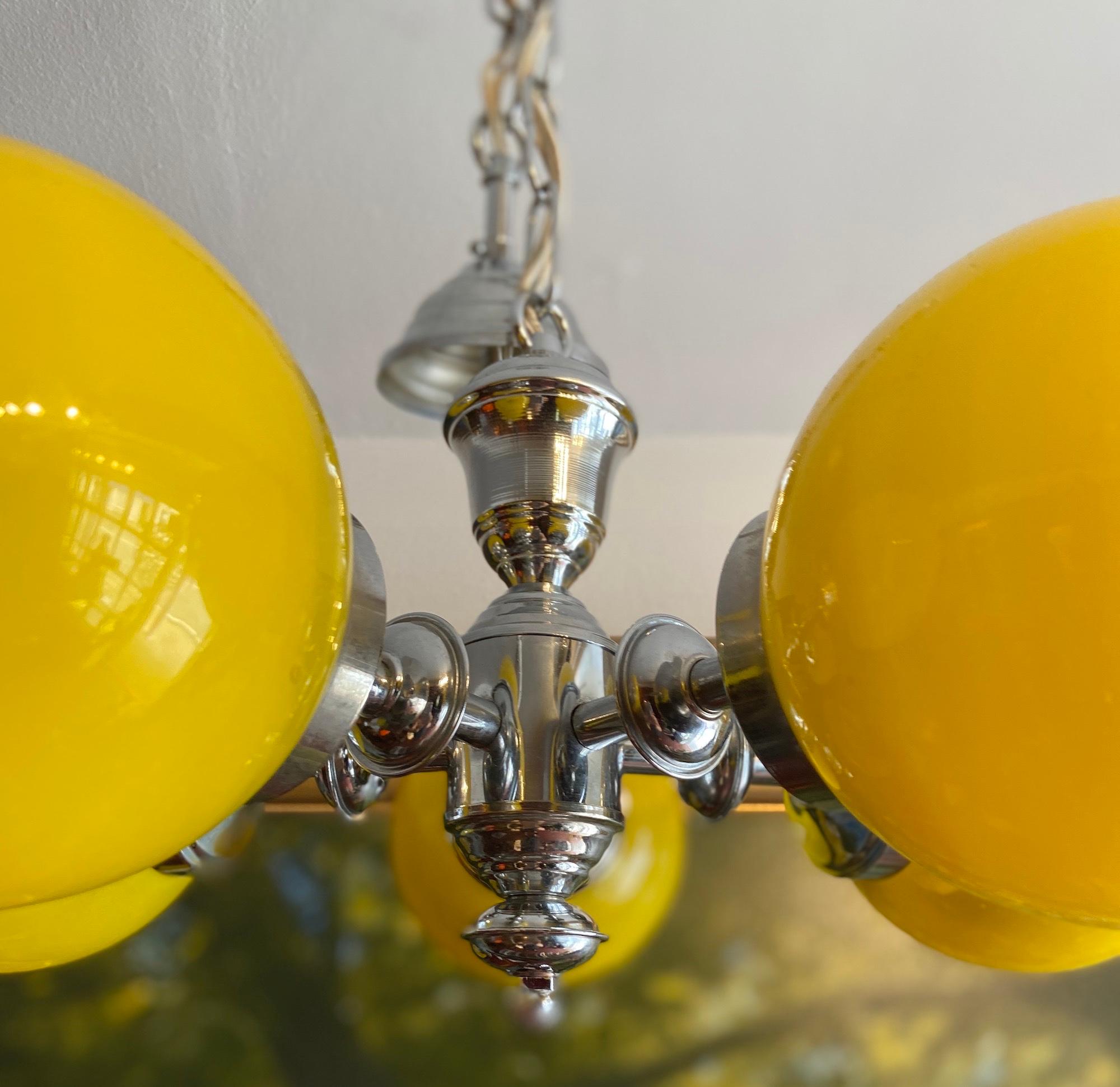 A striking midcentury Italian designed pendant hanging light. 

The yellow round shades look vibrant against the chrome finish

Measures: 40 cm diameter.
  