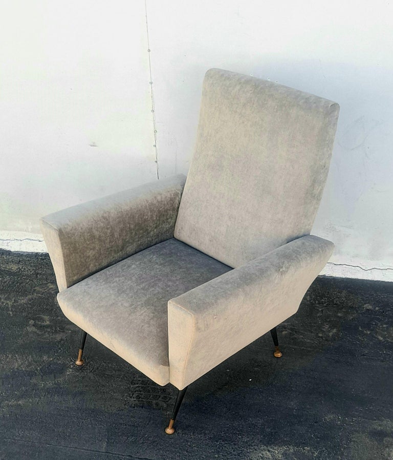 Italian club chair refurbished and new reupholstered in grey velvet .
Brass and metal legs.