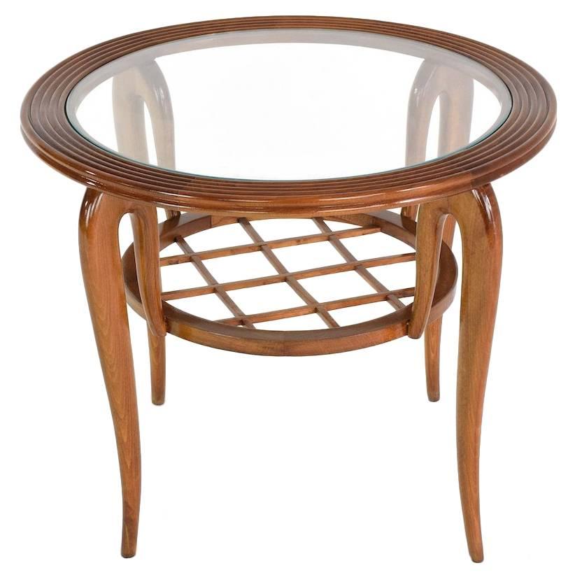 Italian 20th century vintage coffee, side or end table designed by Paolo Buffa composed of an elegant sculpted design in solid beech frame with a circular glass tabletop and a graphic midcentury design lower tier.

Fully refinished.
Italy, 1950s.
