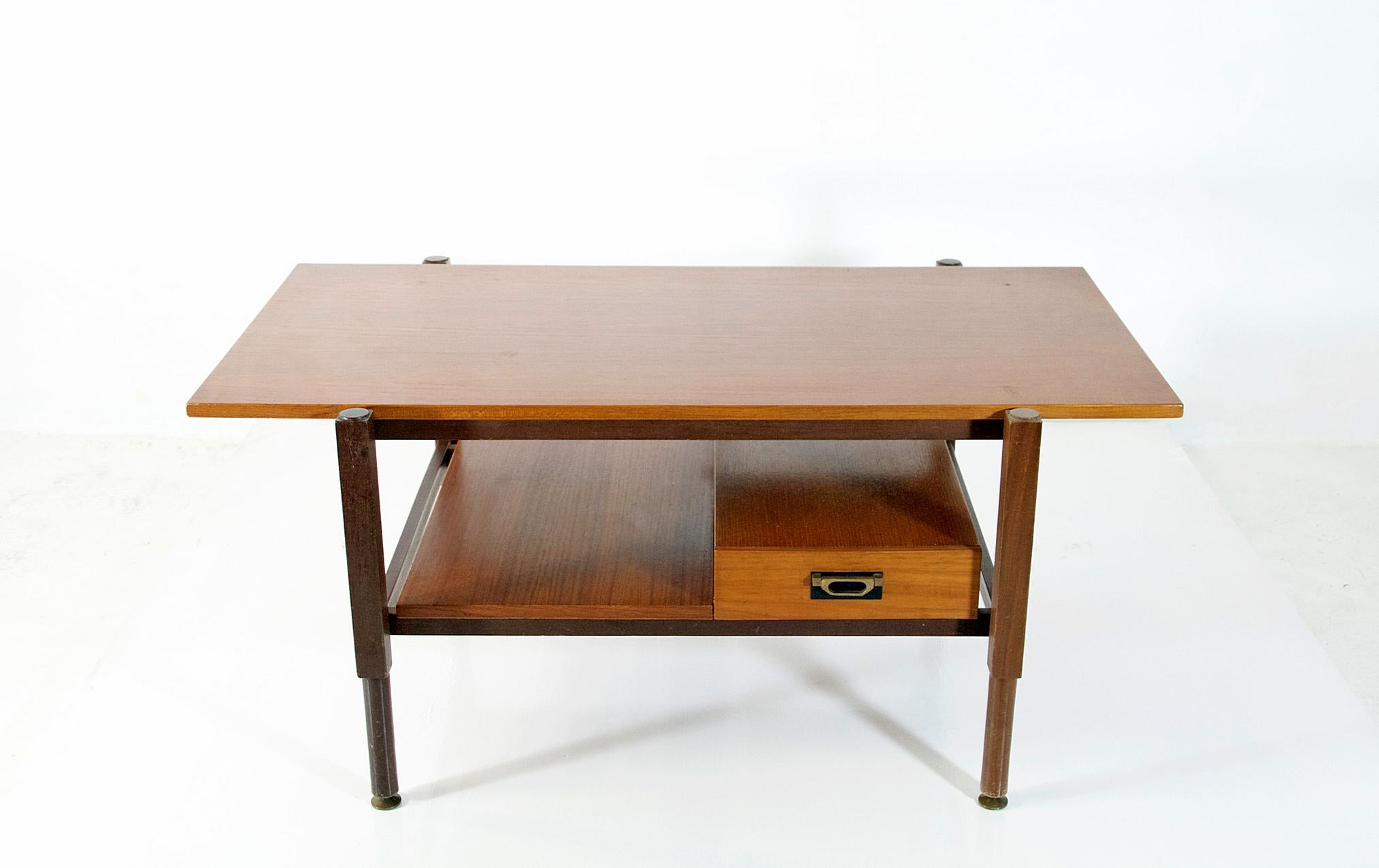 A nice and easy to place two tired coffee table with a convenient drawer made in Italy during the 1960's in teak.