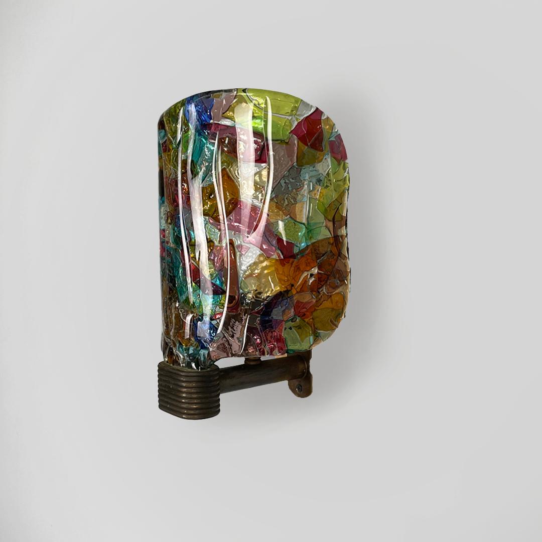 Italian mid century colorful glass wall lamp by Venini, 1950s
Wall lamp with a finely crafted curved glass diffuser. The support structure is made of metal.
The lampshade is made of different colored glasses and has a smooth surface.
Produced by