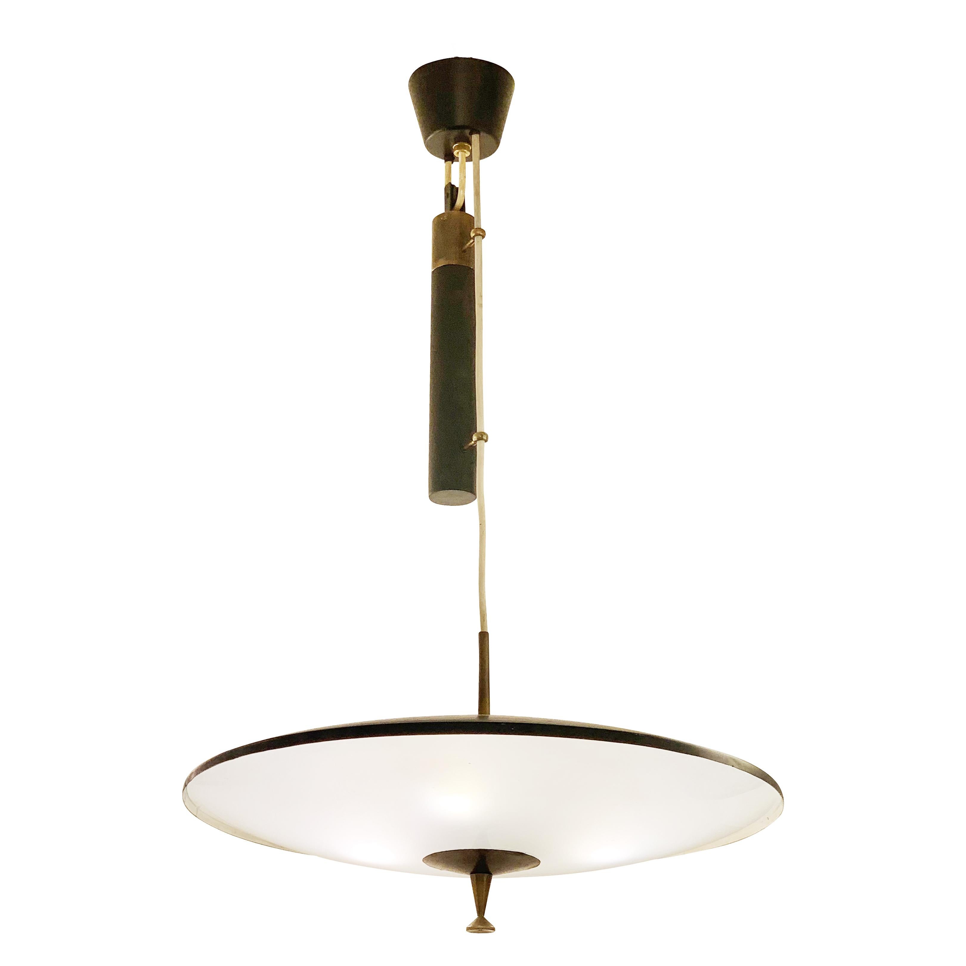 Italian Mid-Century pendant with a counter balance mechanism that allows for easy height adjustments. Black lacquered hardware with brass accents. The frosted glass diffuser conceals three light sources. 

Condition: Excellent vintage condition,