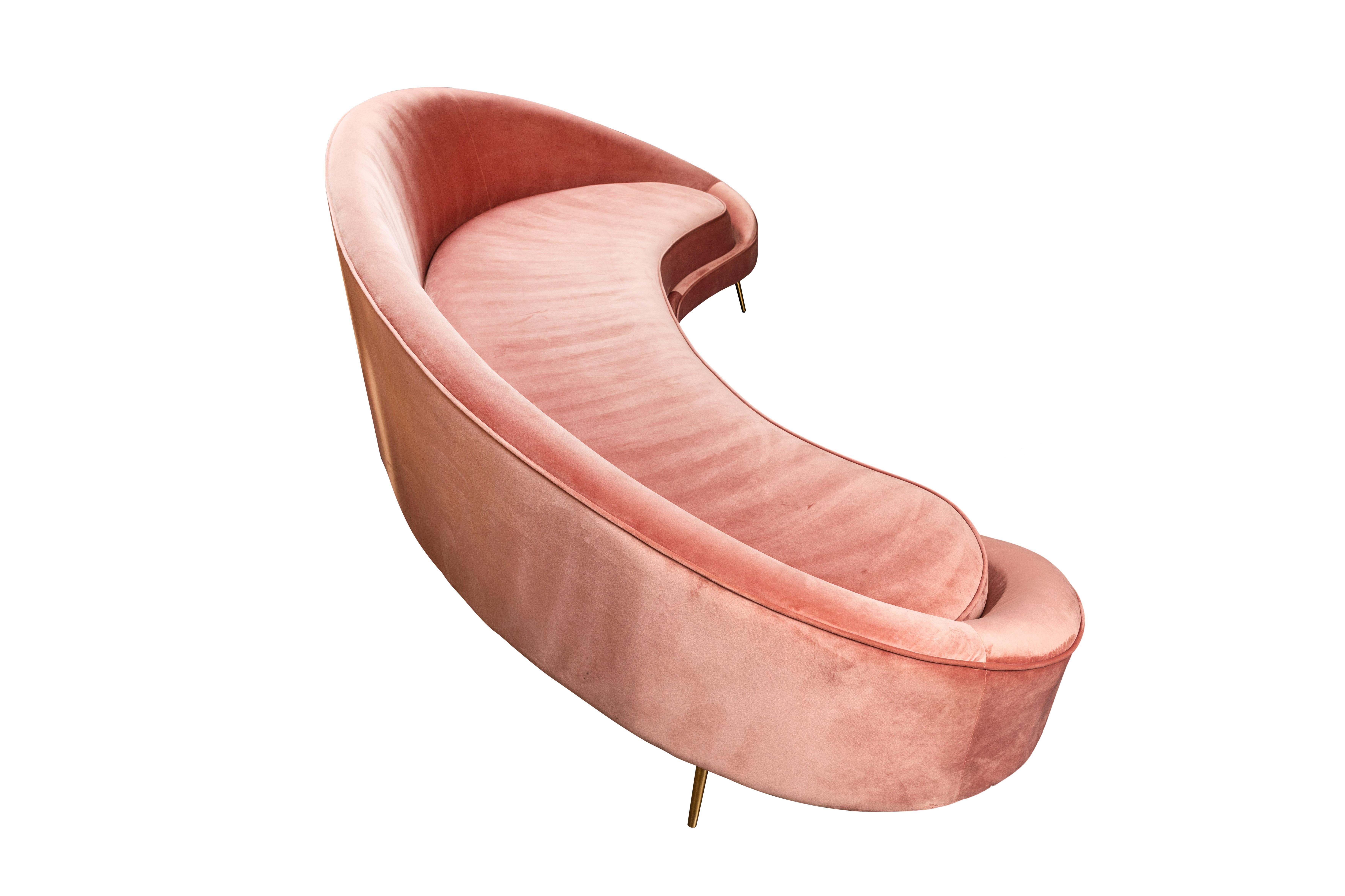 Slinky, sexy, and oh-so-of-the-moment, Italian midcentury curved sofa on six brass legs in the style of Federico Munari. the pink ultrasuede upholstery is in very good vintage condition and can be used as is, or reupholstered in the fabric of choice.