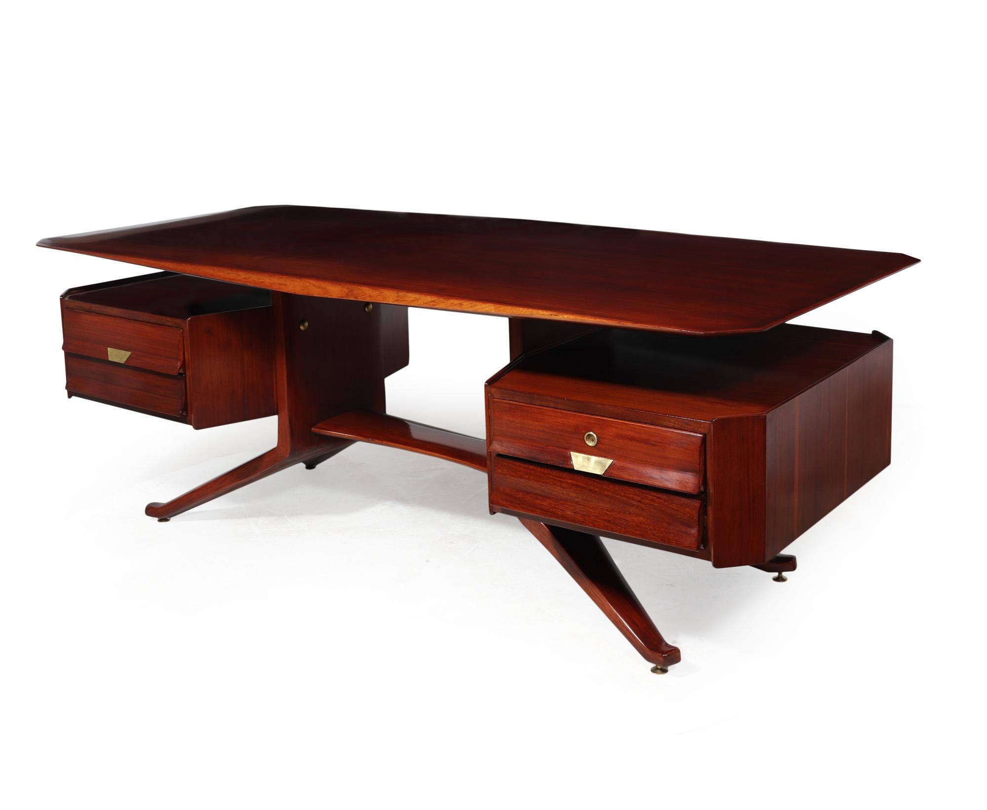 MID CENTURY DESK BY DASSI
This mid-century executive desk, crafted in Italy using cherry wood during the 1960s by Vittorio Dassi, exudes a stunning and timeless design. Featuring a unique floating pedestal with a chamfered top that gives the
