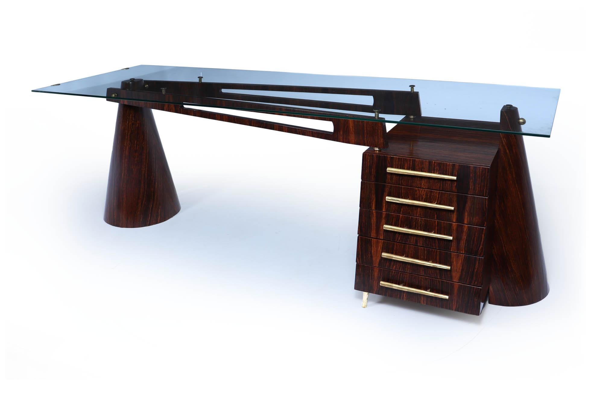 Italian Mid Century Desk 
A truly exceptional piece of mid-century design with this rare Italian desk, crafted in the 1960s from luxurious Macassar ebony. Its striking silhouette is complemented by a sleek tempered glass top and elegant brass