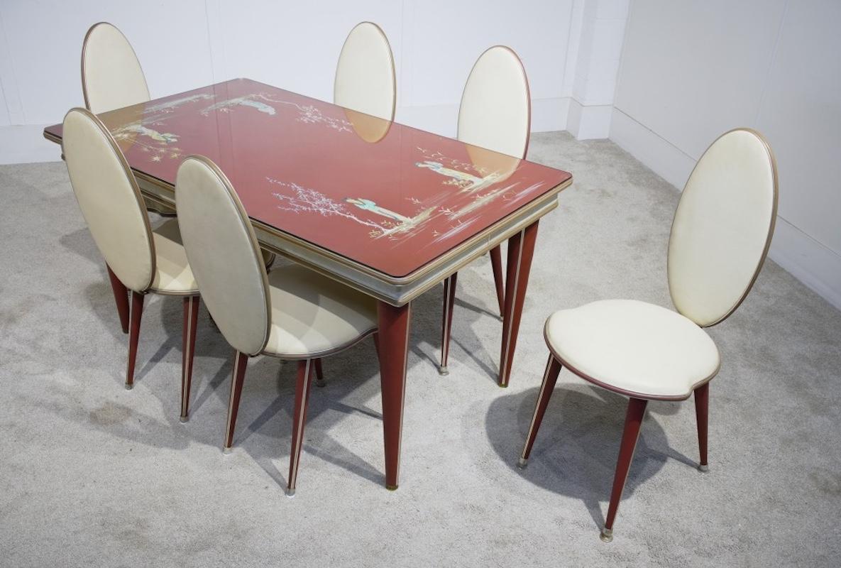 Gorgeous Mid Century Italian dining table and chair set by Umberto Mascagni
Originally retailed by Harrods
Set consists of table and six matching chairs
Cinnnabar red Chinoiserie top covered in cream and textured vinyl
Hand painted Chinoiserie
