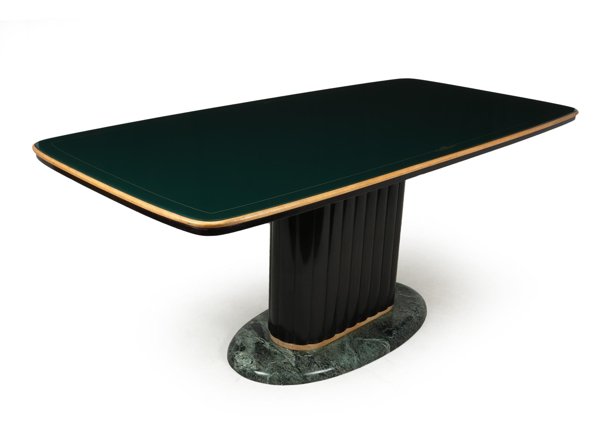 A Dining table designed and produced in Italy by Vittorio Dassi in the 1950’s, this example is in excellent original condition it has a green marble base with ebonised reeded center column and a green glass top surface, there are a few light