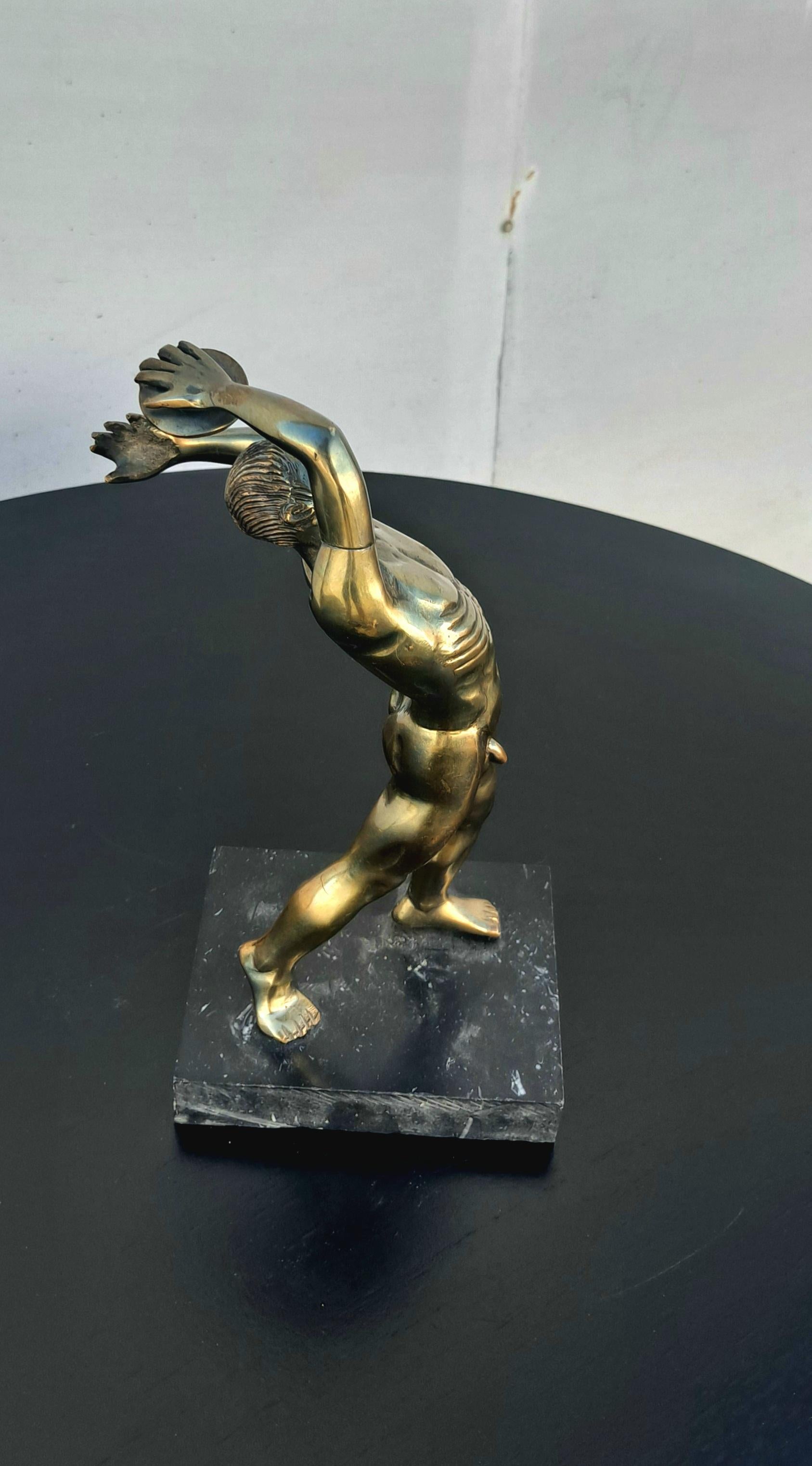Italian Discobolus metal sculpture on the marble base. Brass is over the metal base. Meticulous metal work.