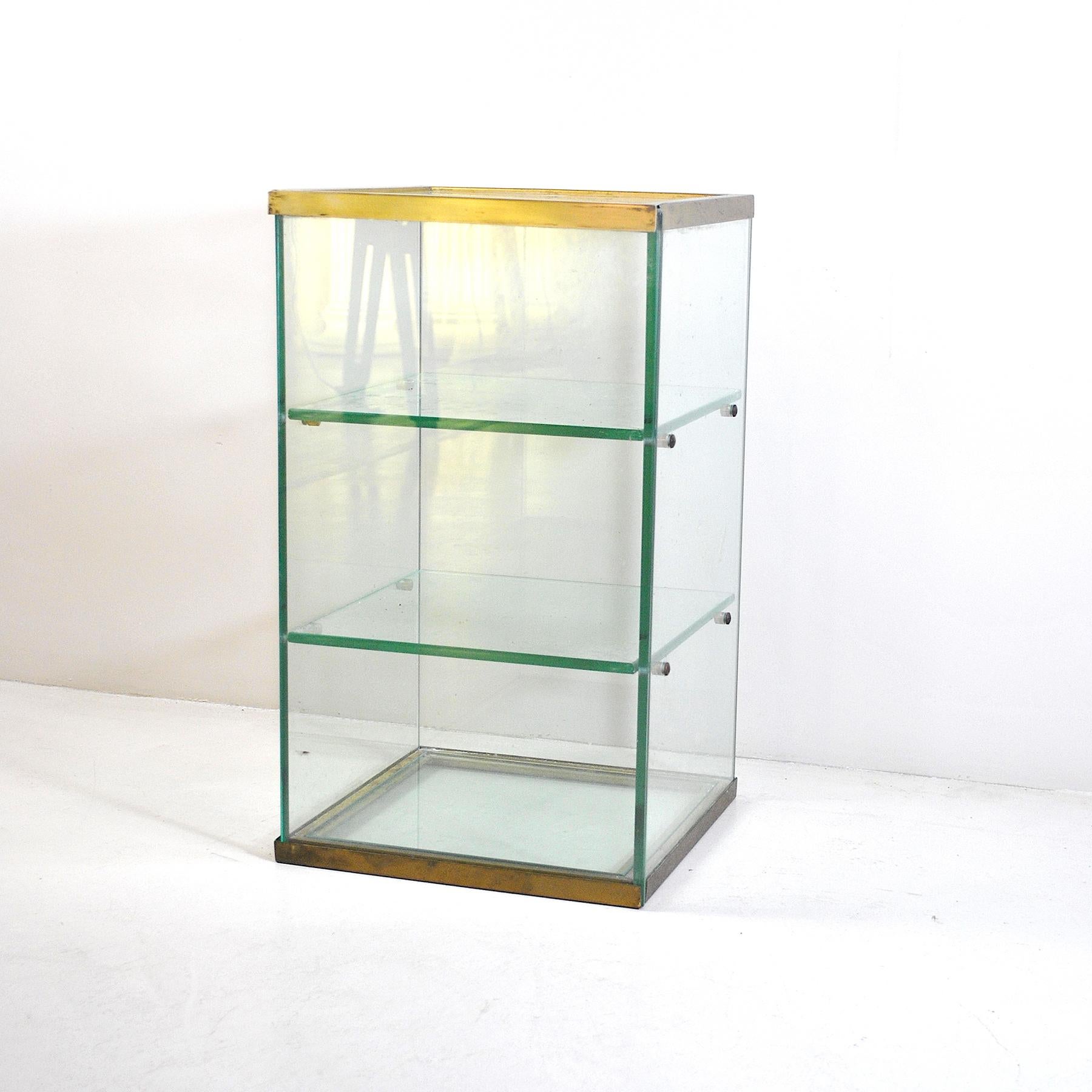 Glass display cabinet with brass structure from the 1950s.