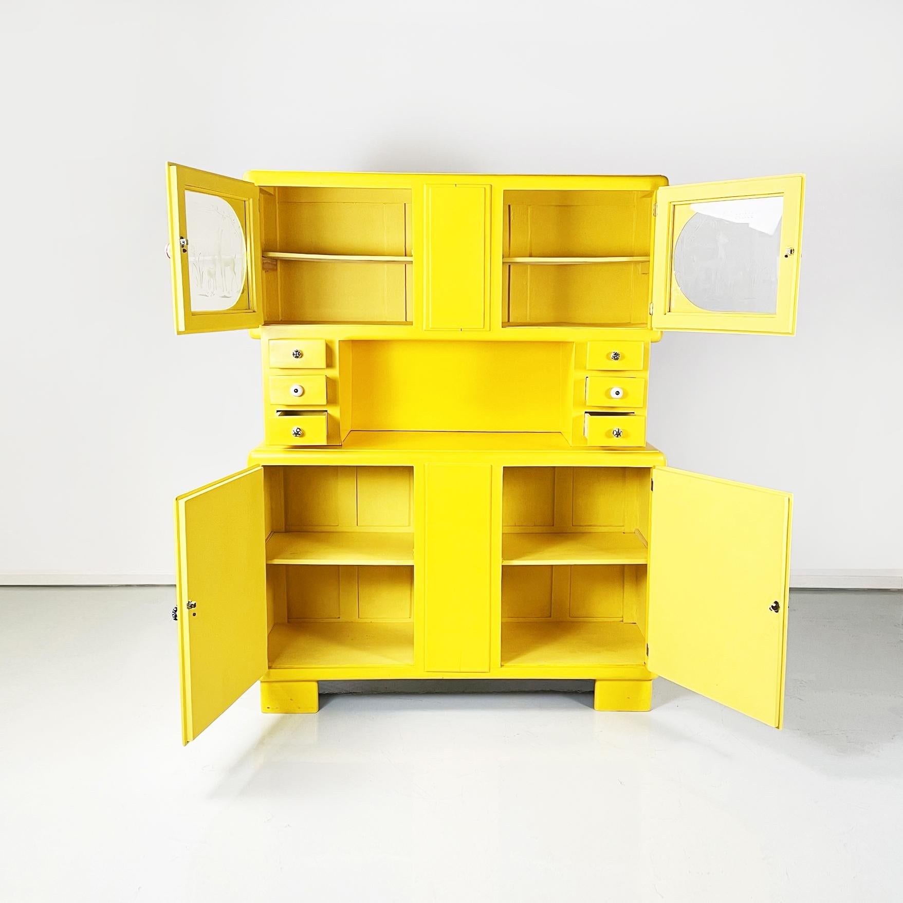 Italian mid-century Double body chest of drawers in bright yellow wood, 1960s.
 Double body chest of drawers in bright yellow painted wood. In the upper part there are two glass doors with a wooden frame, on which two fawns are painted. Internal