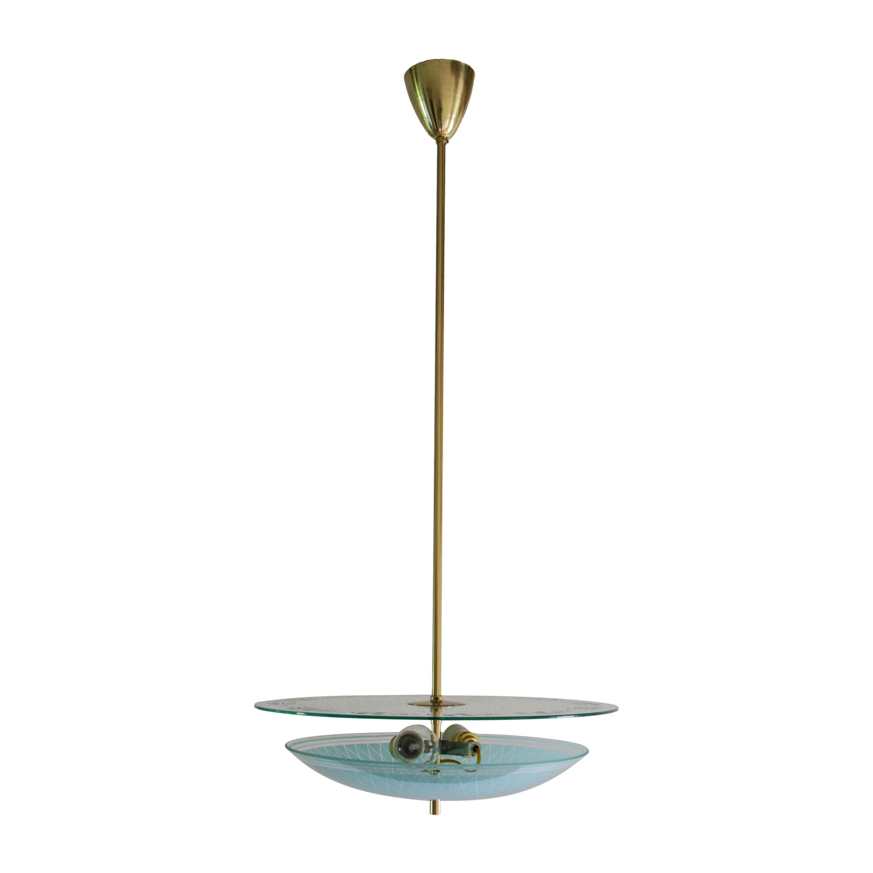 Italian Mid-Century Modern double disc pendant lamp in turquoise color, 1950.
Polished brass structure, curved silkscreen printed glass, and transparent flat glass with frosted floral print. 
The restoration was made with great care by a