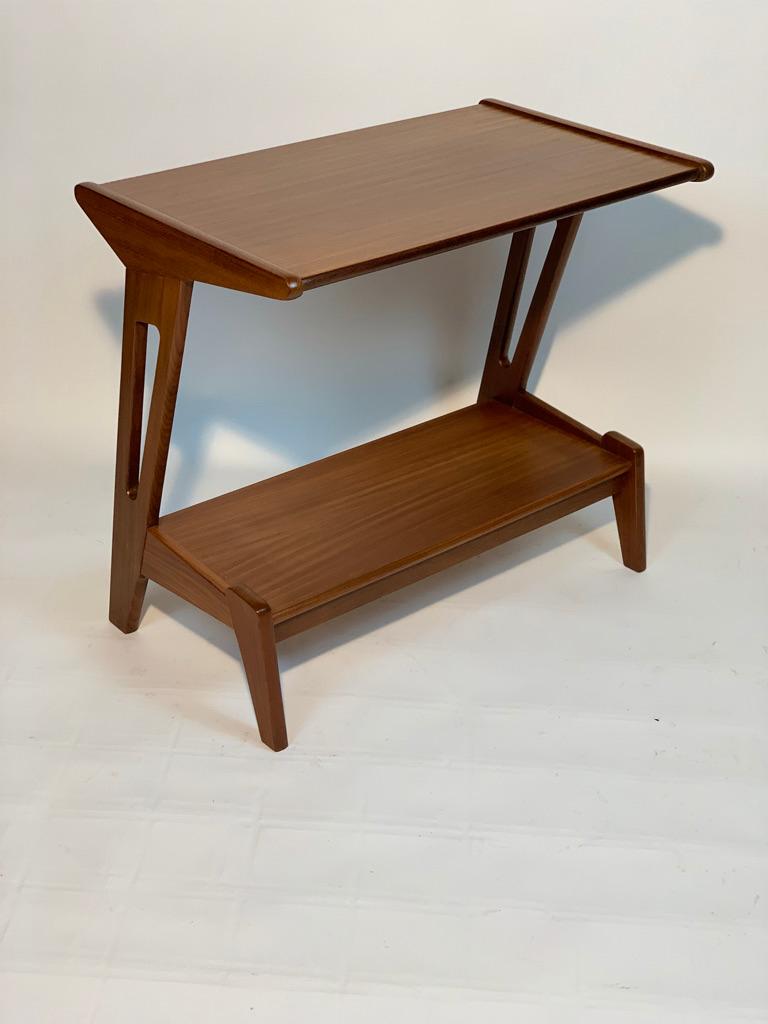 Mid century rectangular coffee table with double top, very useful next to sofas or as a small console table, this coffee table is very practical thanks to the double top that can be used for magazines or books. Built in teak, the shape and details