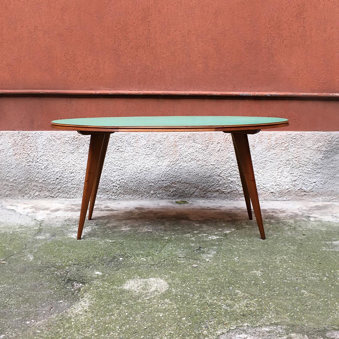 Italian midcentury elliptical solid beech table with green Formica top, 1960s.
Elliptical table with structure in solid beech, shaped leg and original top in water green Formica.
Entirely re-polished structure, small marks on the top but in