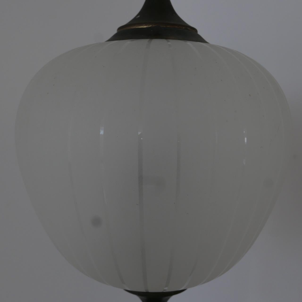 An Italian midcentury two-tone pendant light.

Etched glass with clear stripes.

Patinated brass gallery and base.

Re-wired and ready to hang.

Dimensions: 59 height x 28 diameter to the top of the gallery, 15 cm of original chain. No