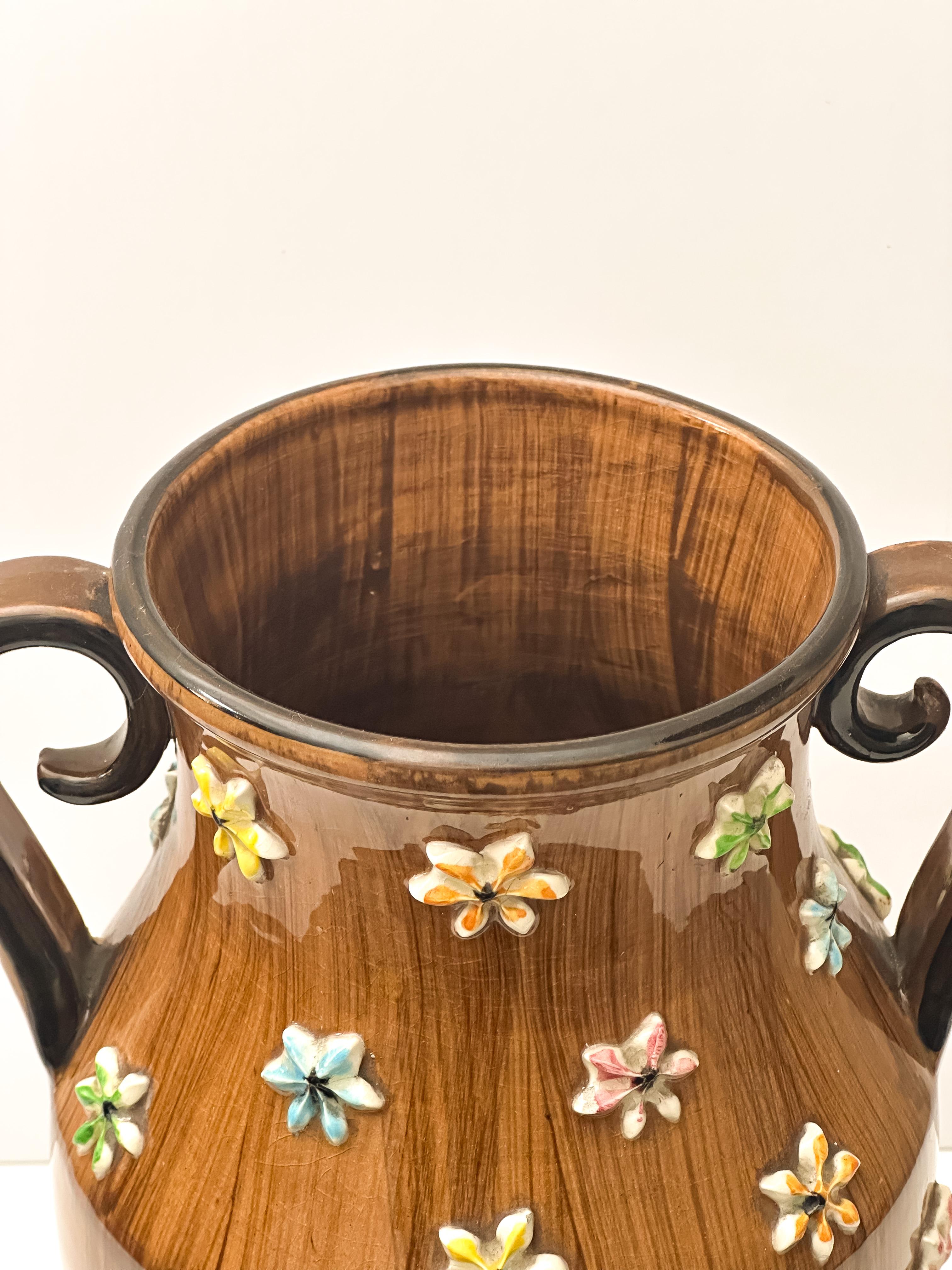 A large double-handled urn vase crafted by the renowned ceramicist Fratelli Fanciullacci, this piece is a wonderful example of the playful and colourful ceramic works of mid-20th-century Italy. 

Dating to the 1960s, the large, urn-shaped body and