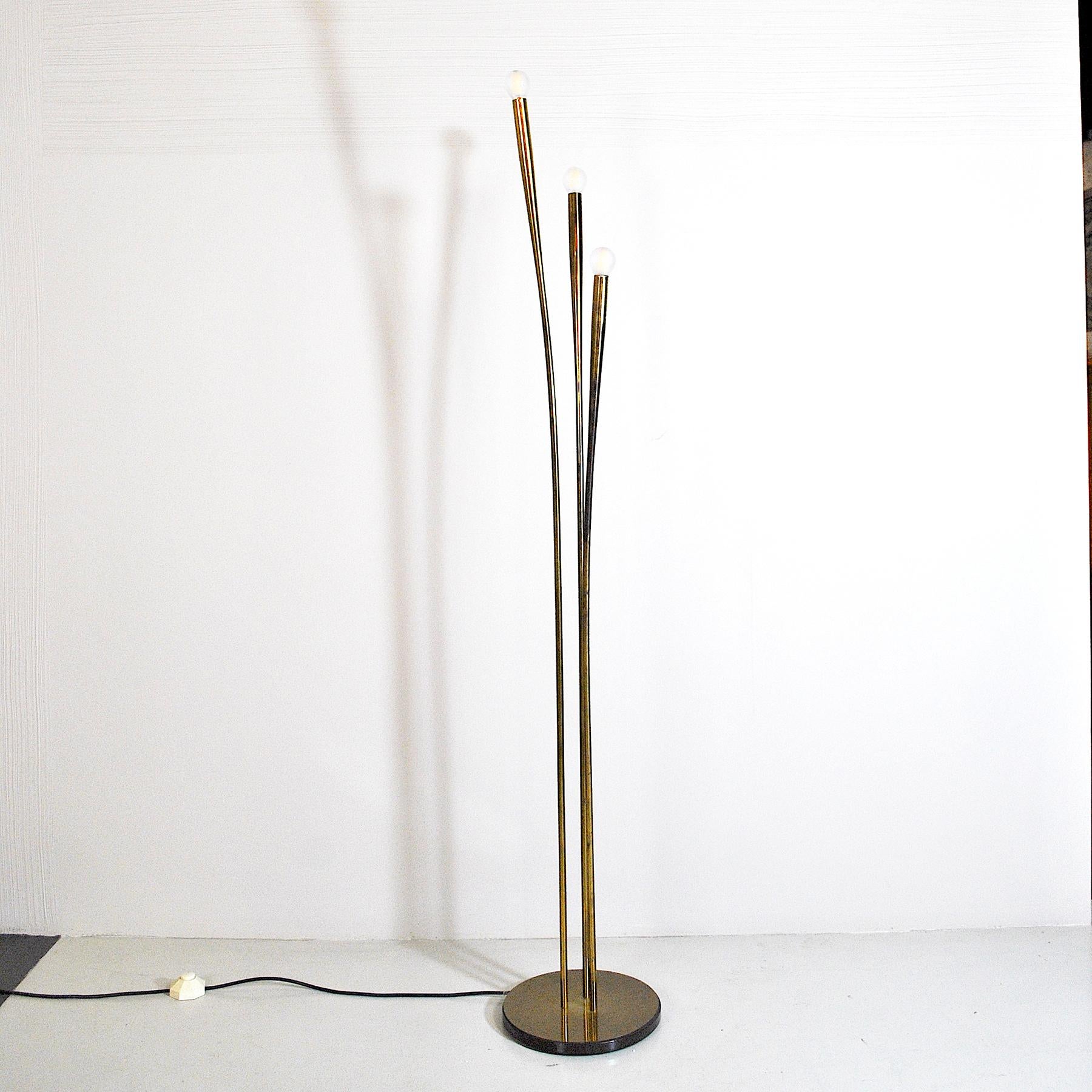 Floor lamp with circular base and three stems in the style of Oscar Torlasco from the 1950s.